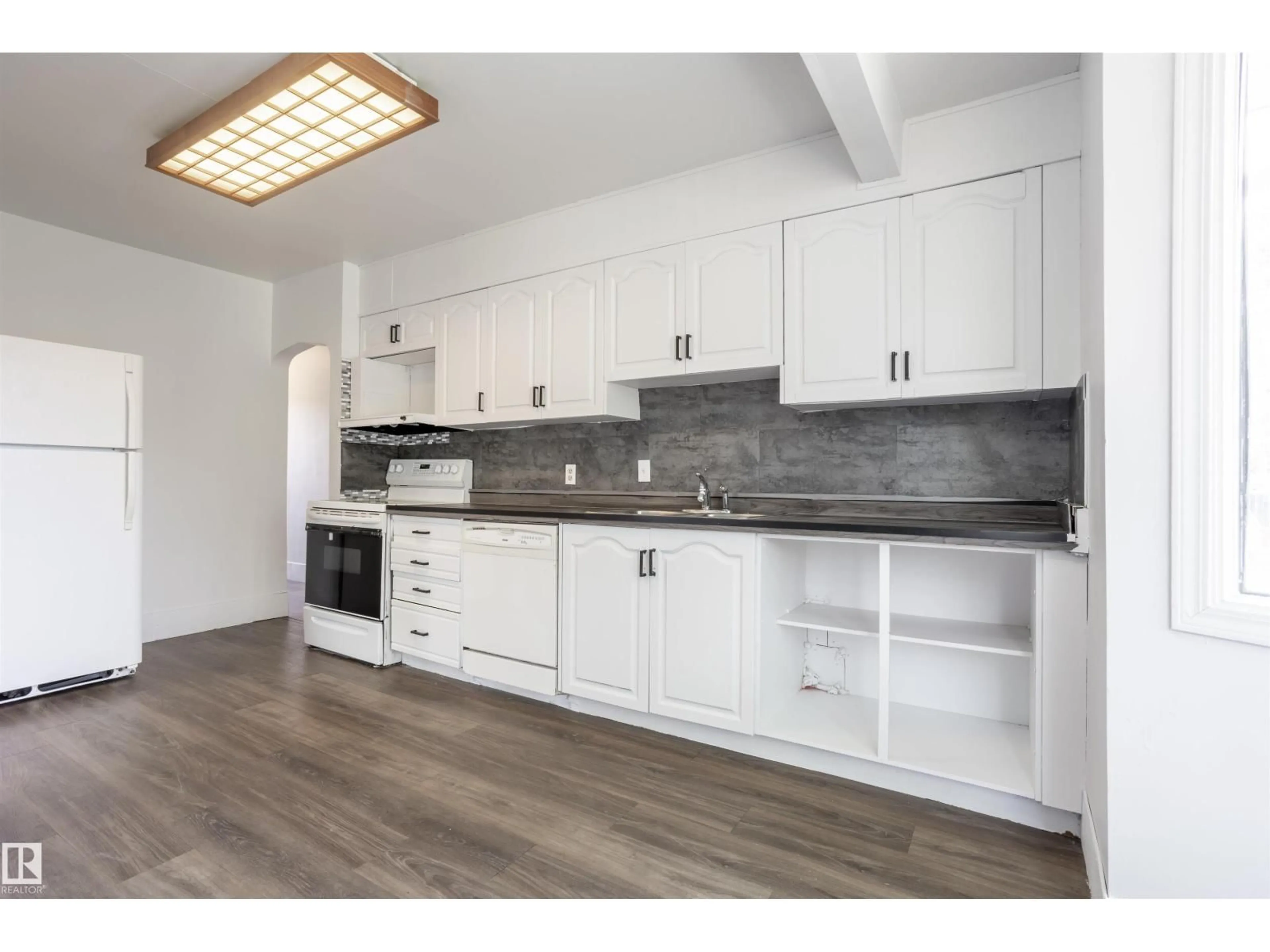Open concept kitchen, wood/laminate floor for 13716 115 AV, Edmonton Alberta T5M3B3