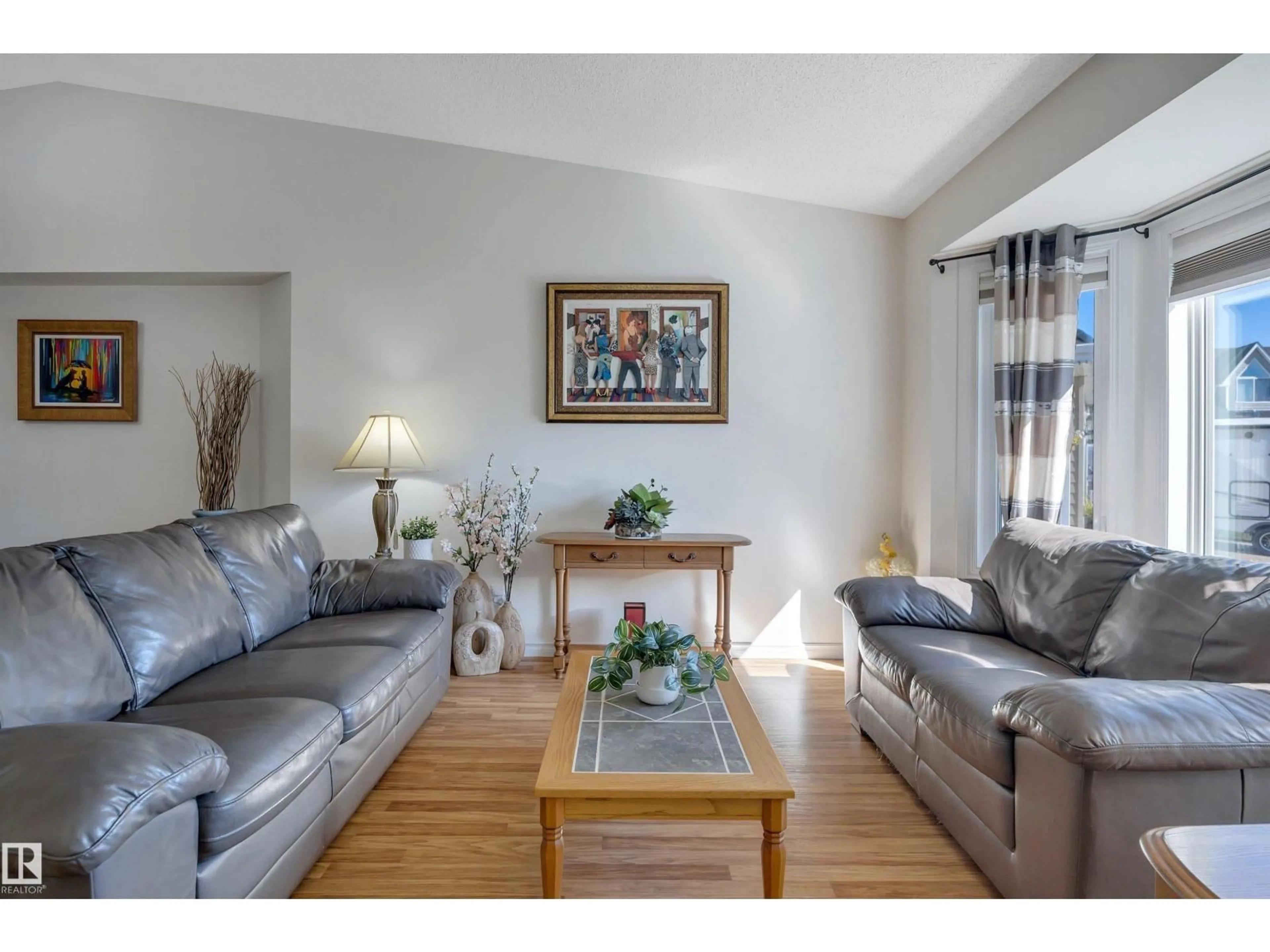 Living room with furniture, wood/laminate floor for 5735 152A AV, Edmonton Alberta T5A4X7