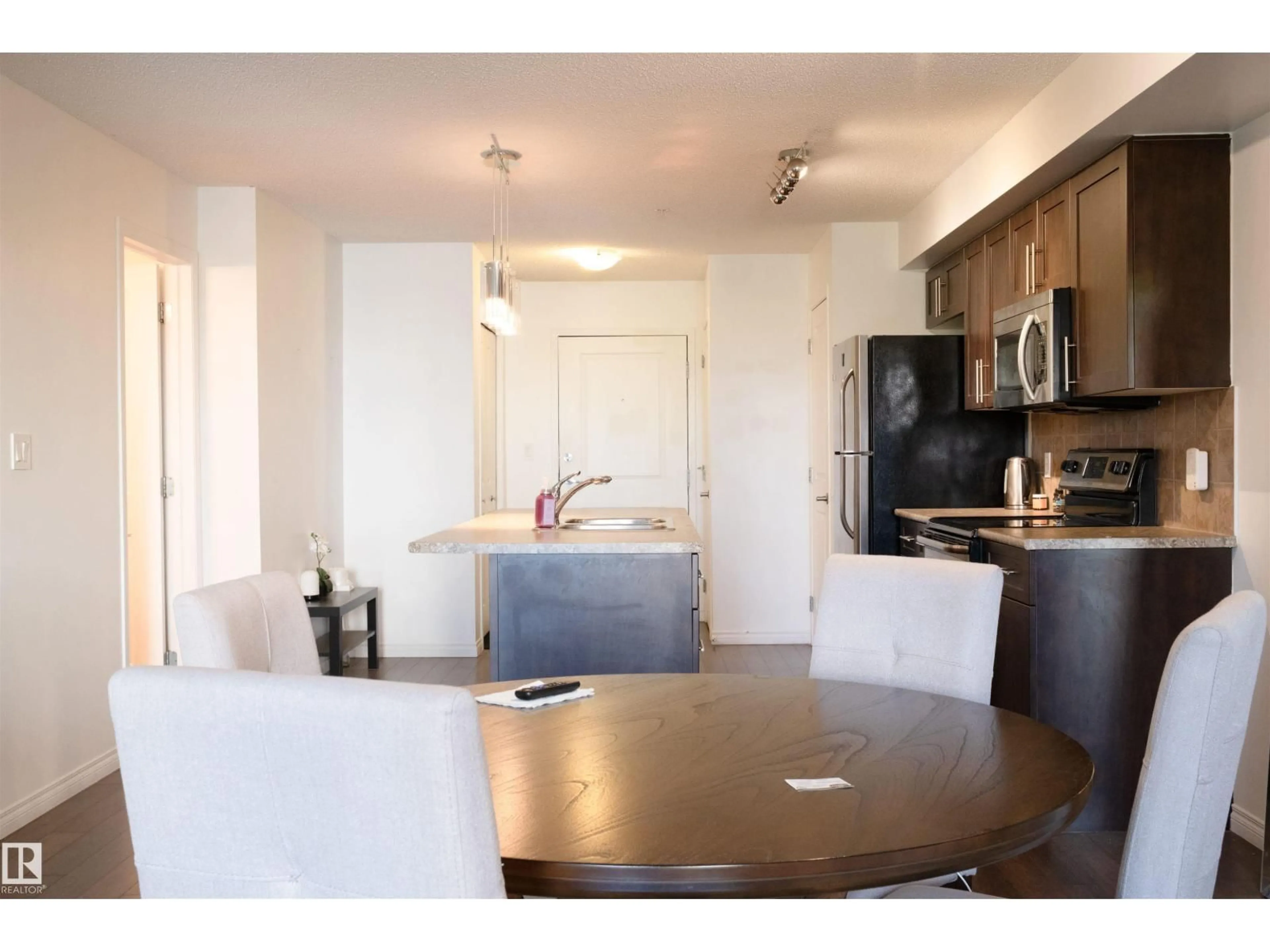 Open concept kitchen, wood/laminate floor for 111 - 206 AMBLESIDE DR, Edmonton Alberta T6W0J4