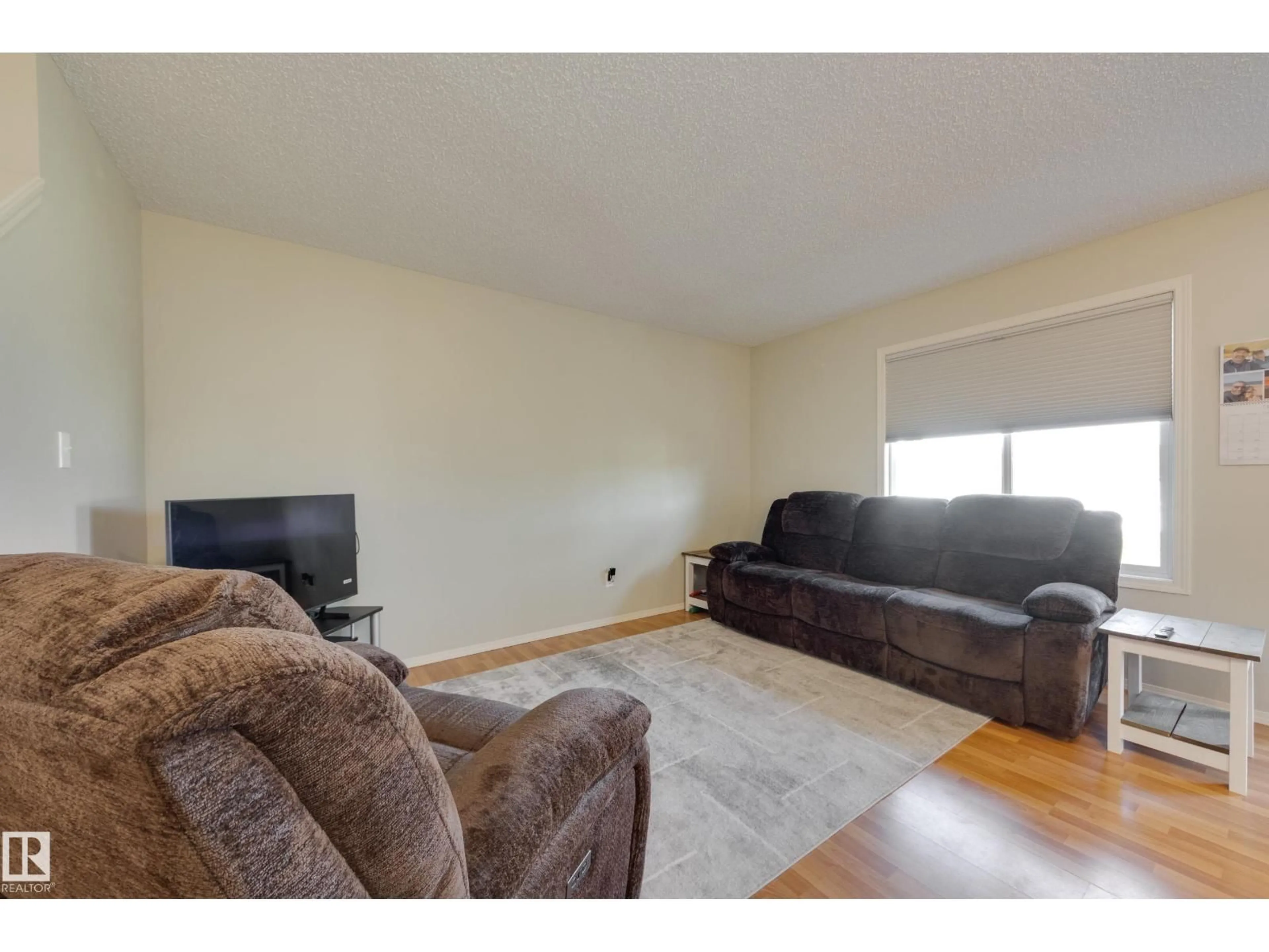 Living room with furniture, wood/laminate floor for 11 - 115 CHESTERMERE DR, Sherwood Park Alberta T8H2W4