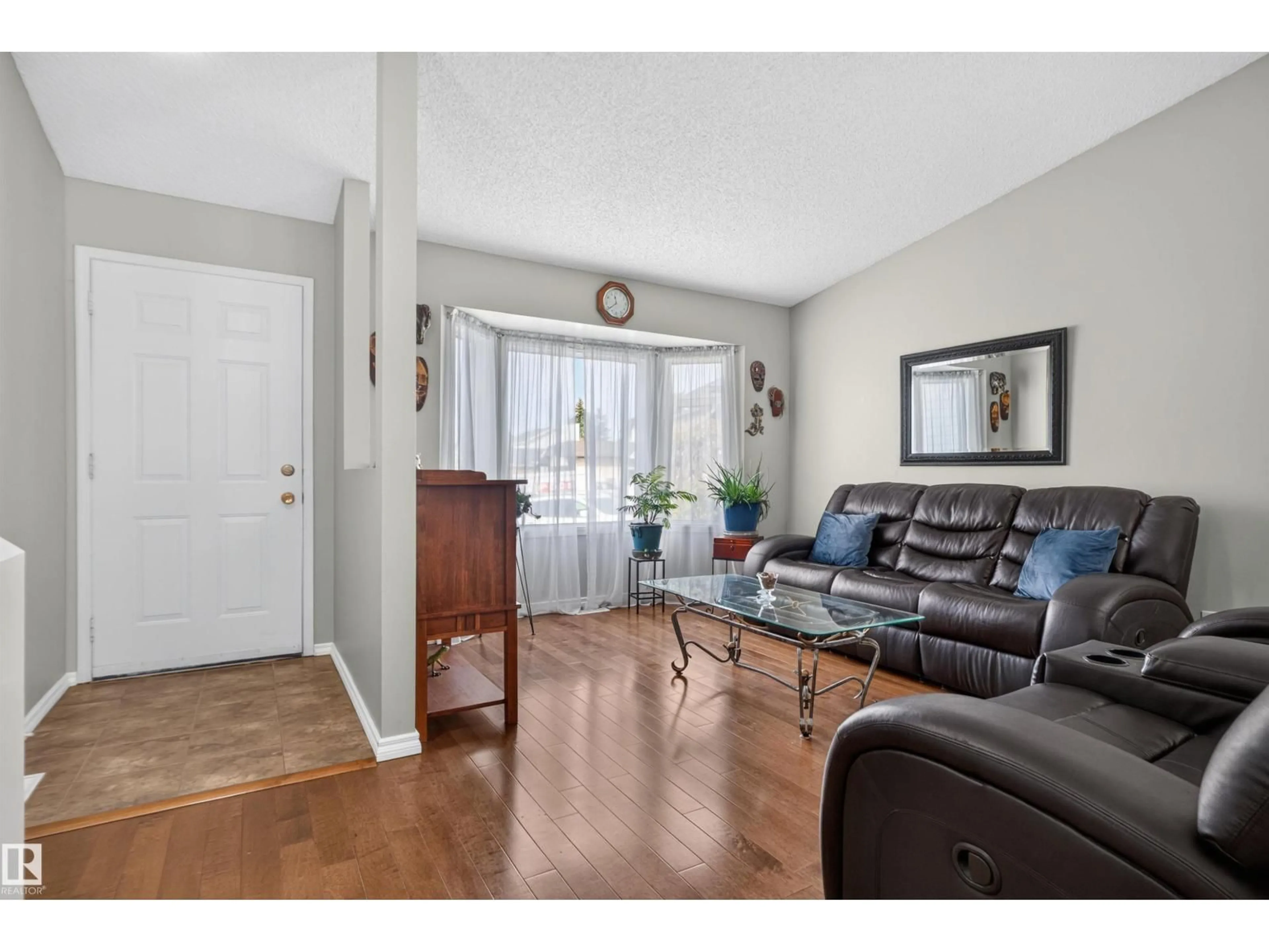 Living room with furniture, wood/laminate floor for 1519 104 ST, Edmonton Alberta T6J5T2