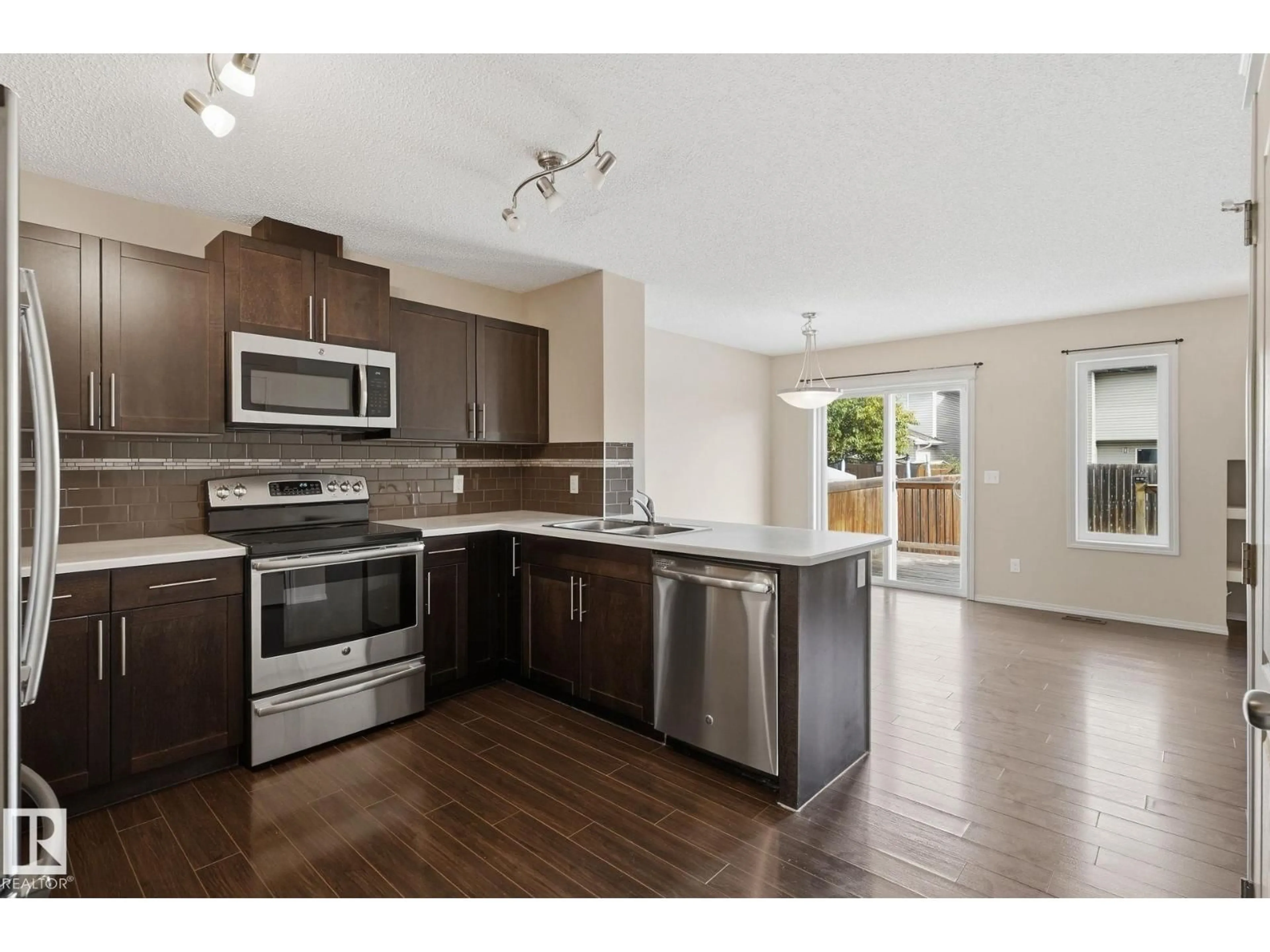 Open concept kitchen, wood/laminate floor for NW - 17015 120 ST, Edmonton Alberta T5X0H6