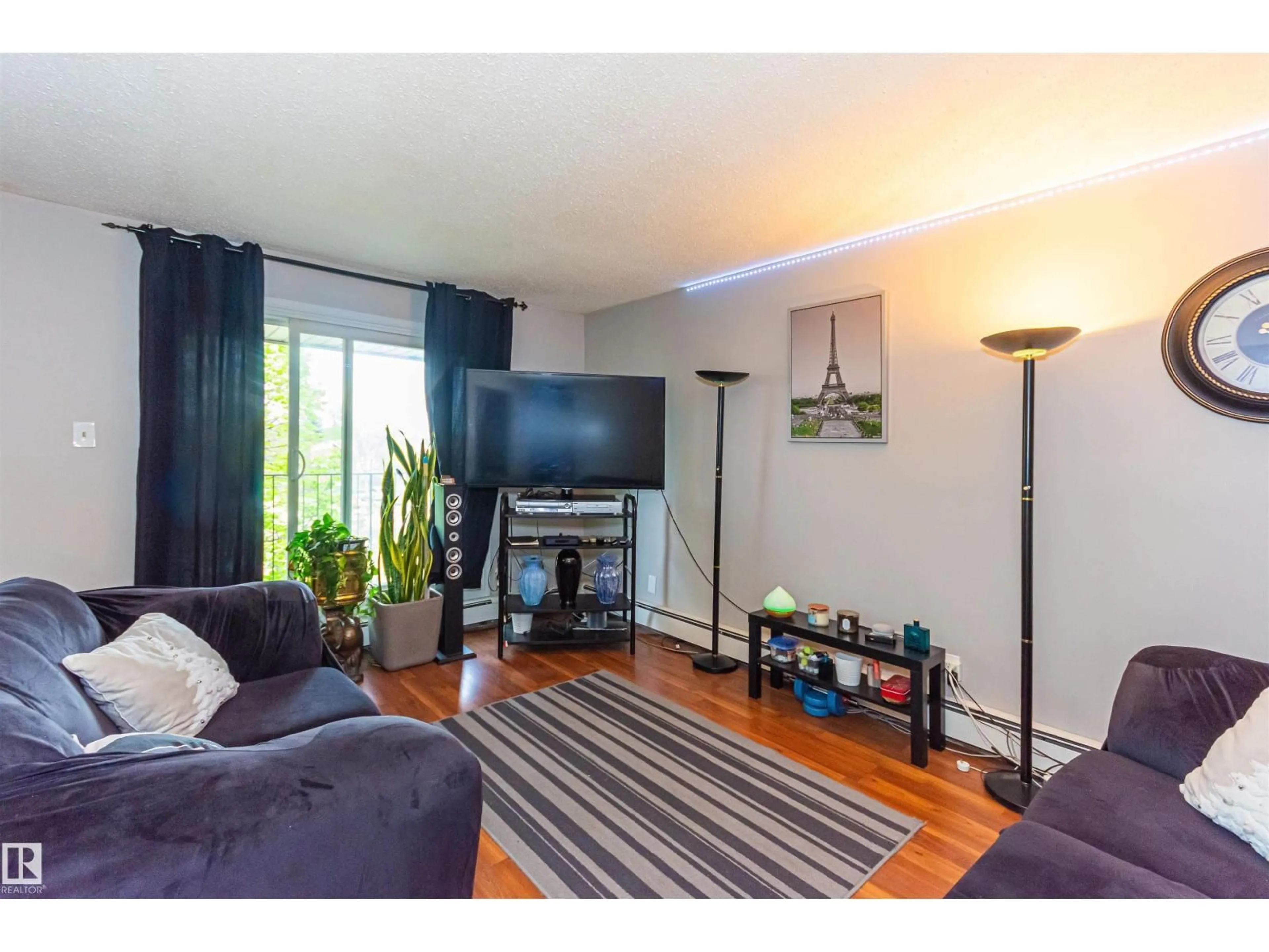 Living room with furniture, wood/laminate floor for 6 - 3819 76 ST, Edmonton Alberta T6K2P9