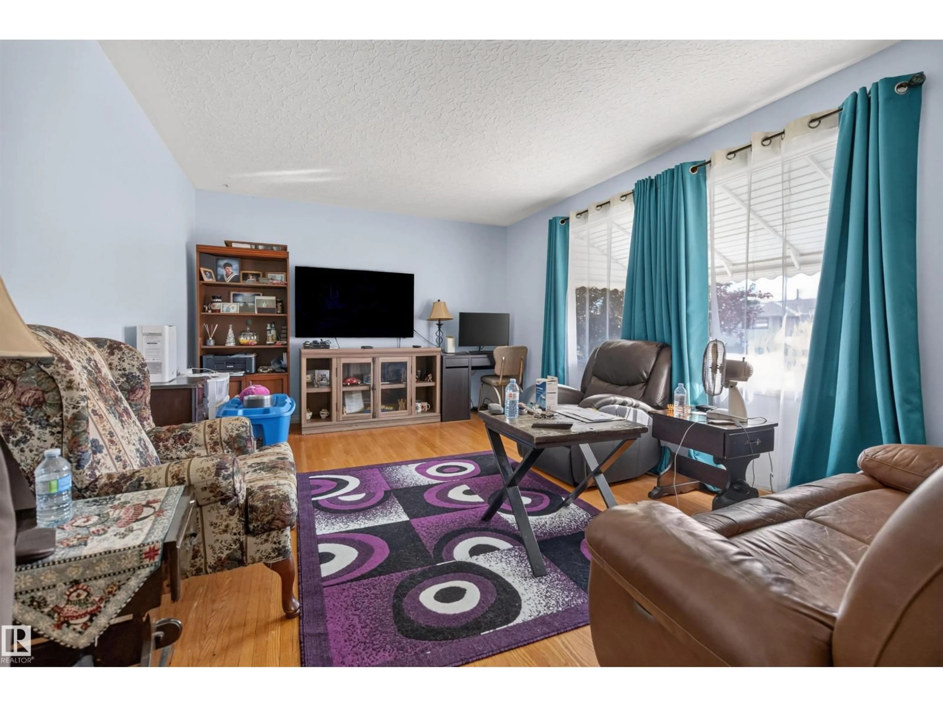 Living room with furniture, wood/laminate floor for 3526 122 AV, Edmonton Alberta T5W1P8