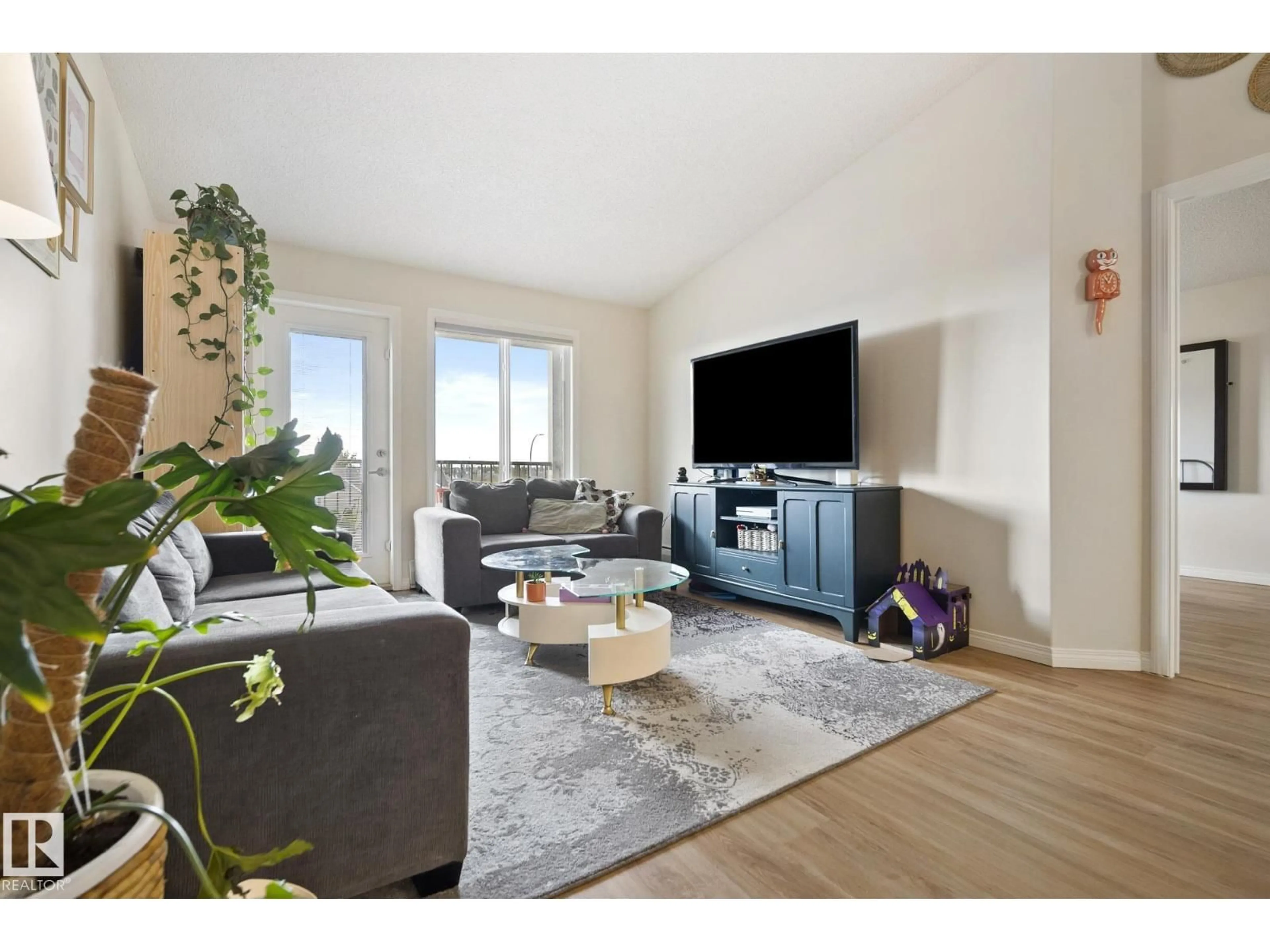 Living room with furniture, wood/laminate floor for 111 - 416 EDWARDS DR, Edmonton Alberta T6X0C4