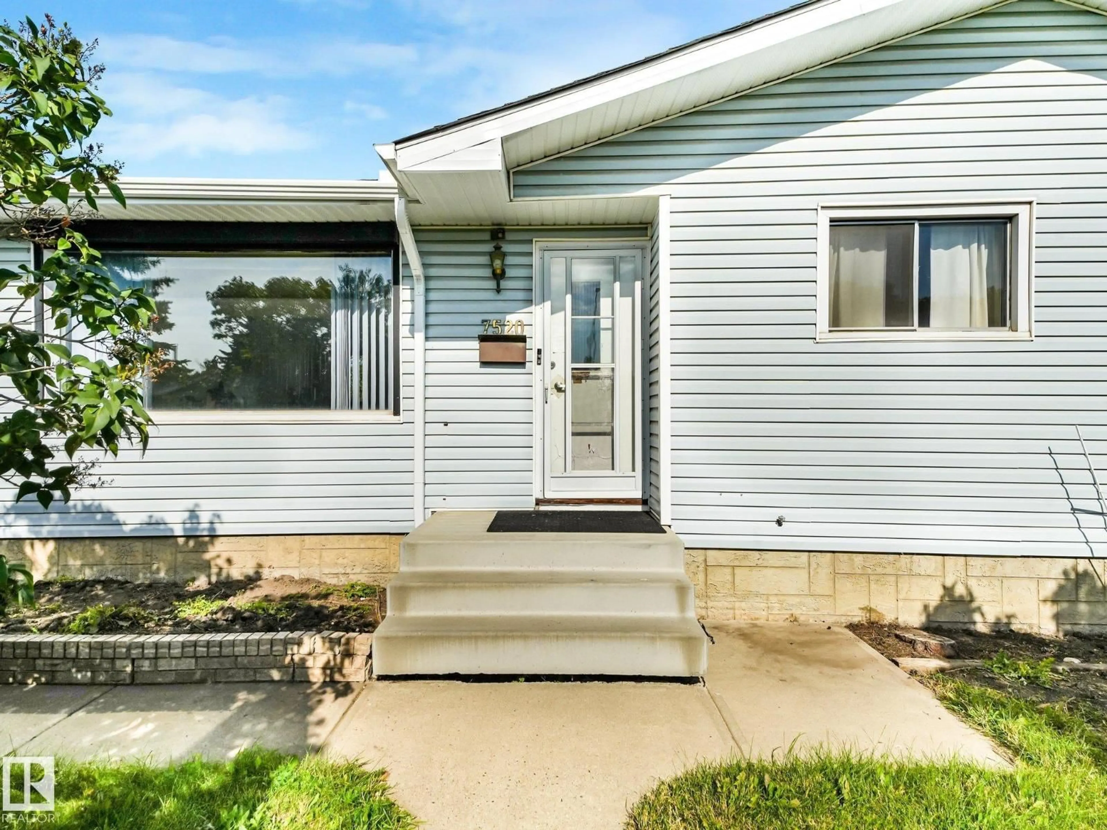 Home with vinyl exterior material, street for 7520 130 AV, Edmonton Alberta T5C1Y2