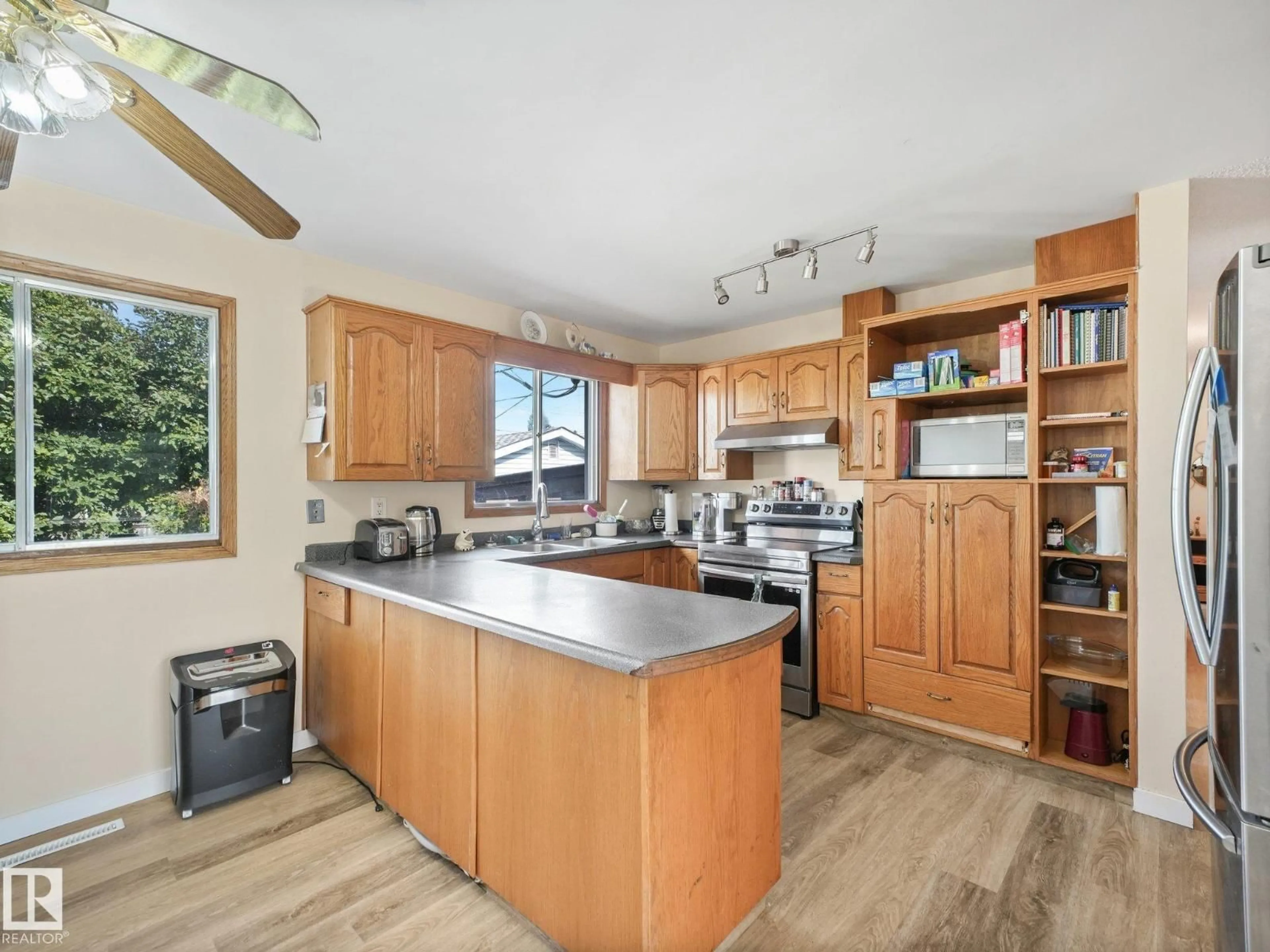 Open concept kitchen, wood/laminate floor for 7520 130 AV, Edmonton Alberta T5C1Y2