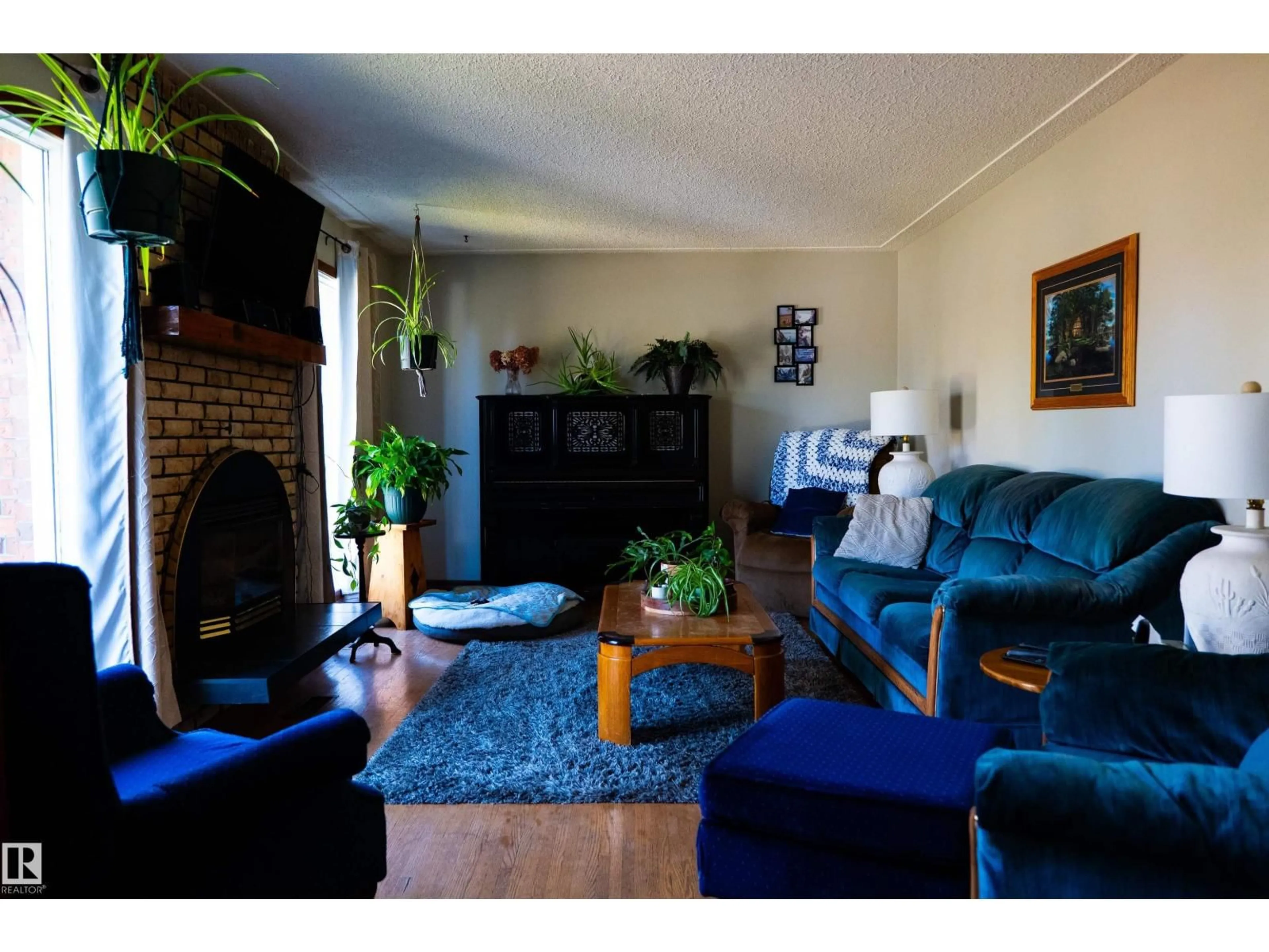 Living room with furniture, wood/laminate floor for 11119 137 AV, Edmonton Alberta T5E1Z3