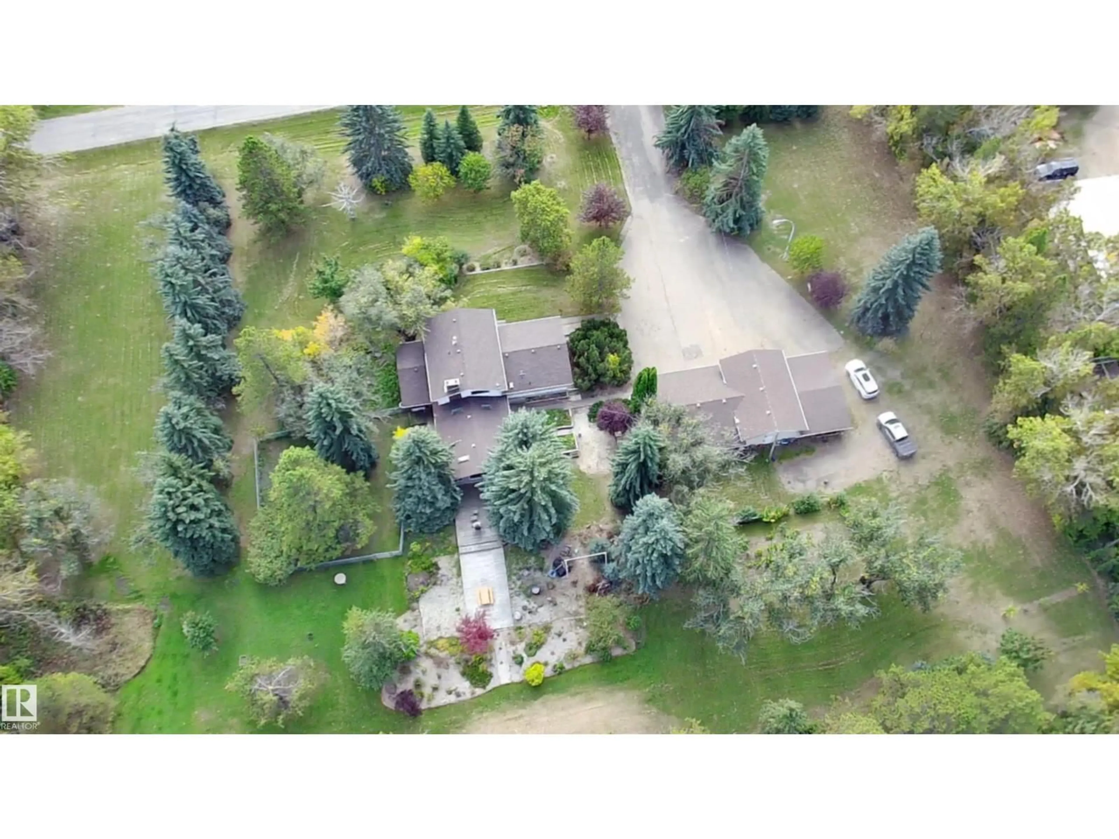 A pic from outside/outdoor area/front of a property/back of a property/a pic from drone, street for 74 22555 TWP ROAD 530, Rural Strathcona County Alberta T8A4T7