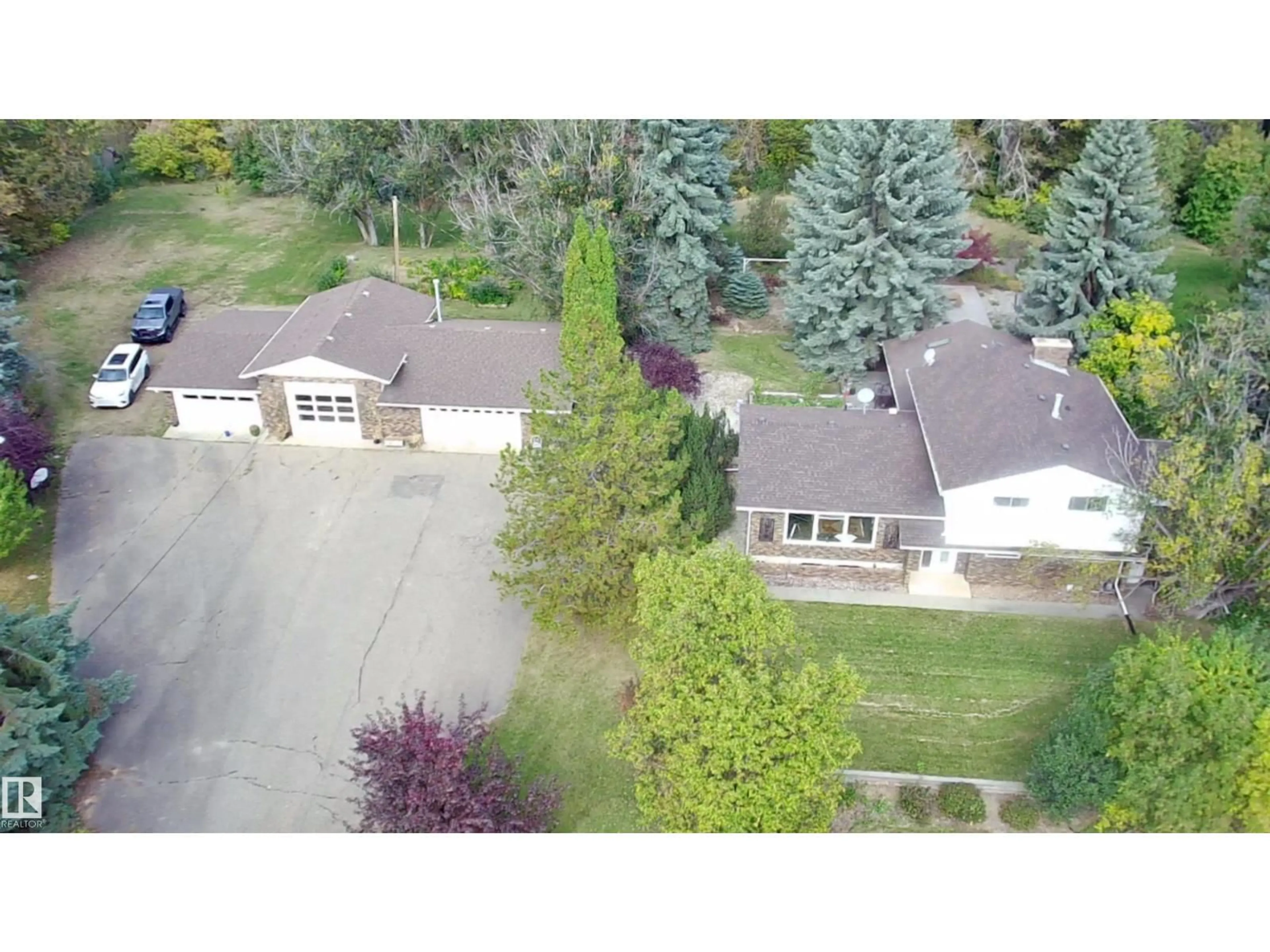A pic from outside/outdoor area/front of a property/back of a property/a pic from drone, street for 74 22555 TWP ROAD 530, Rural Strathcona County Alberta T8A4T7