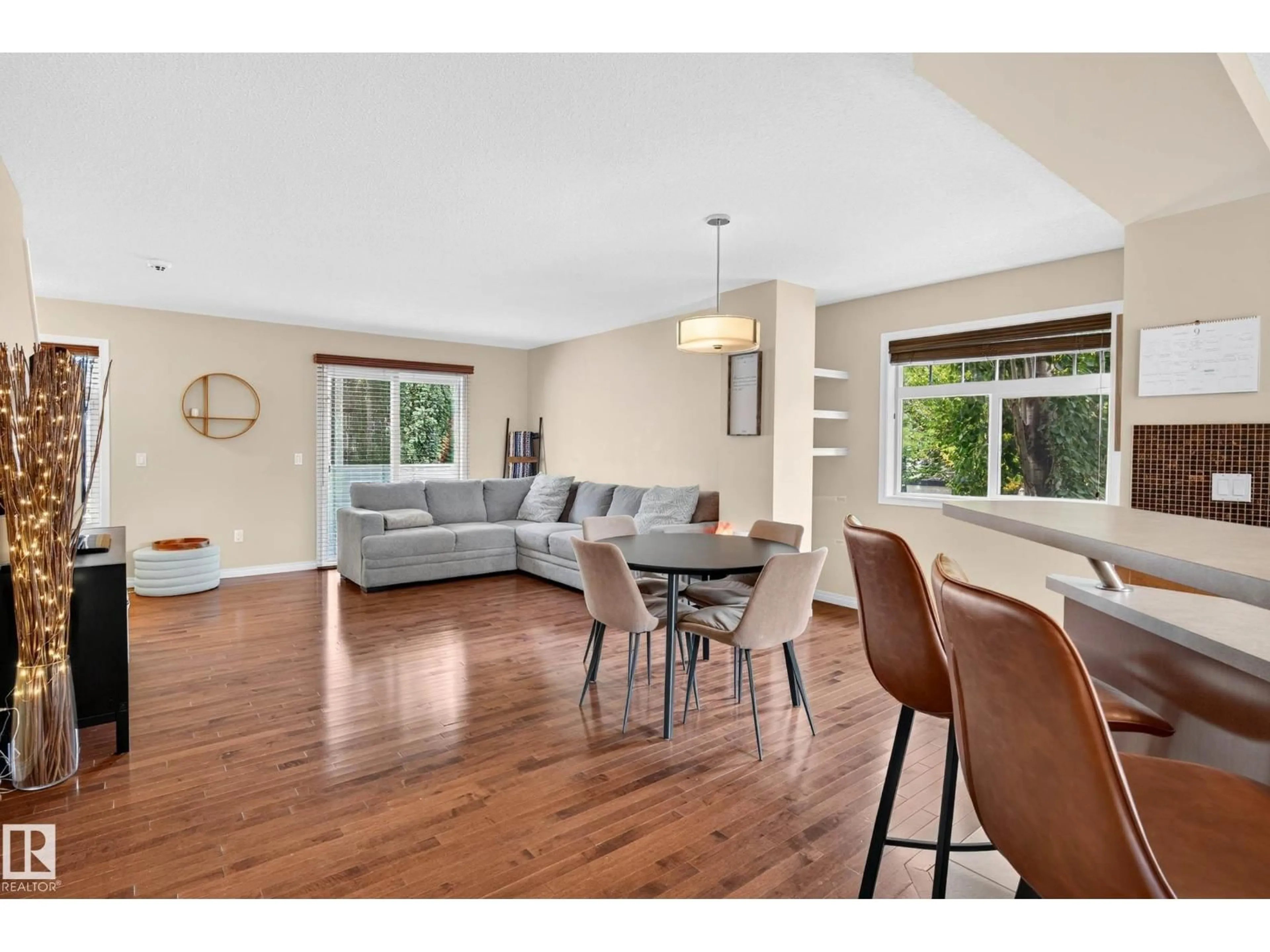 Living room with furniture, wood/laminate floor for 465 - 20 HEMINGWAY RD, Edmonton Alberta T6M0J7