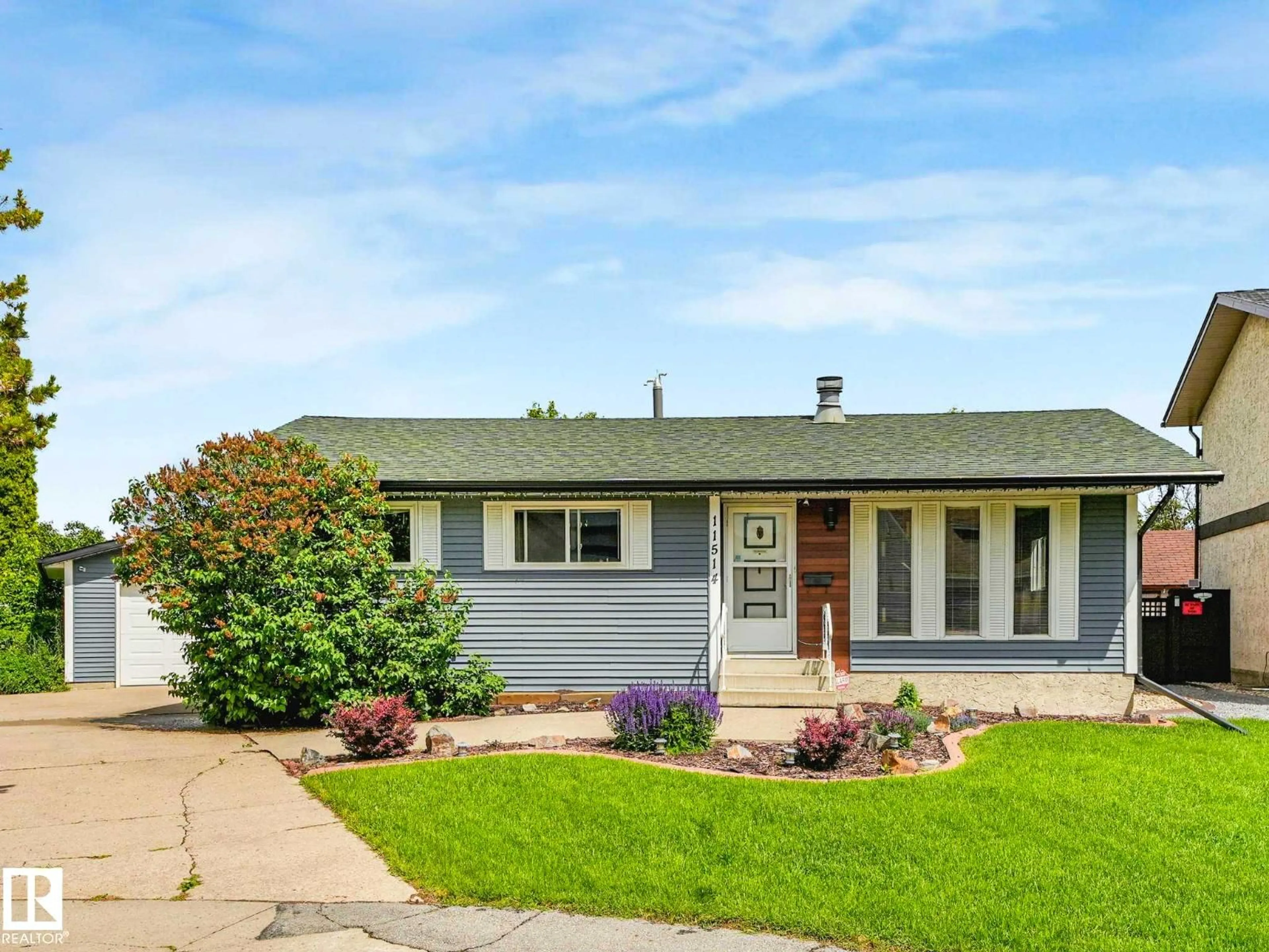 Home with vinyl exterior material, street for 11514 138 AV, Edmonton Alberta T5X3P4
