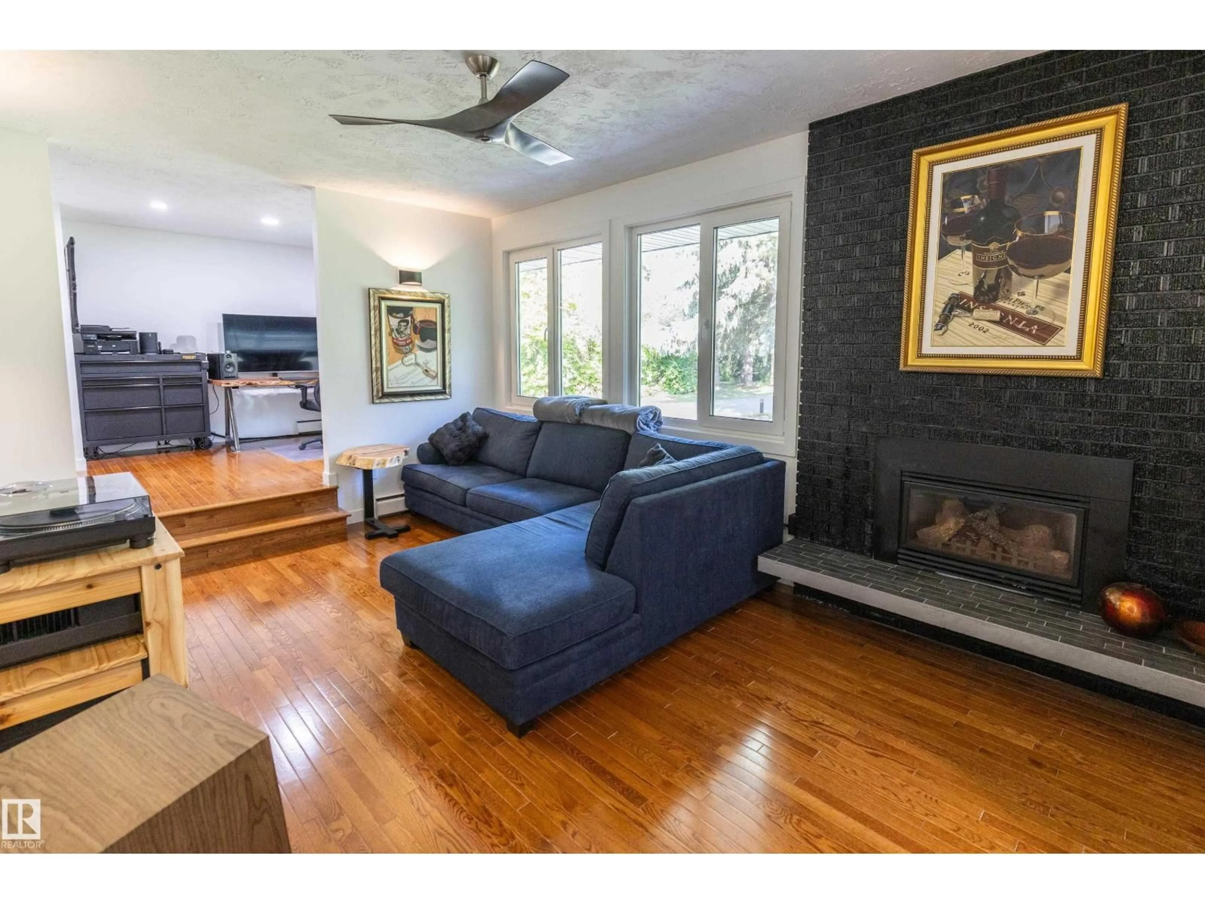 Living room with furniture, wood/laminate floor for 21557 WYE RD, Rural Strathcona County Alberta T8E2J2