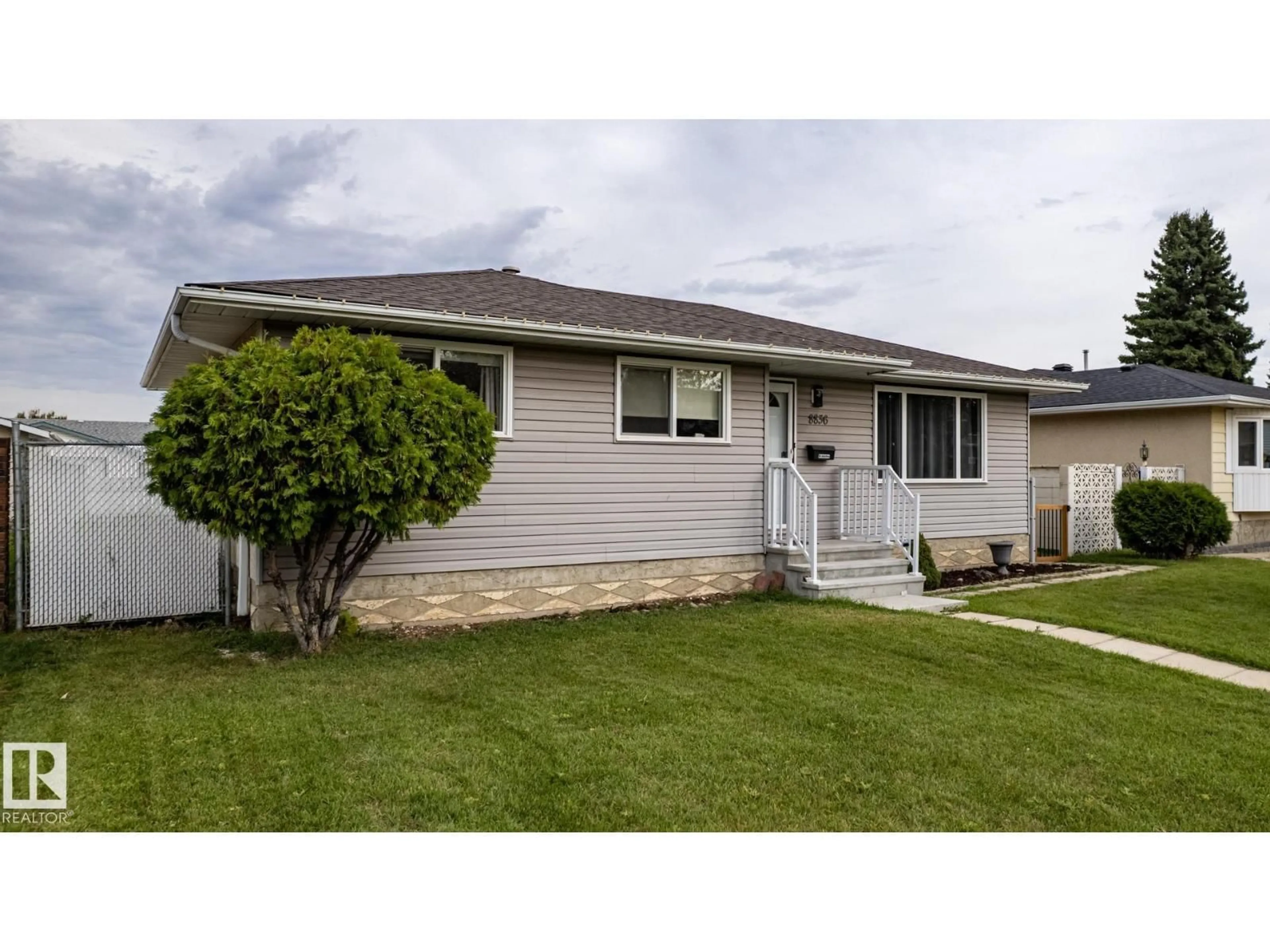 Home with vinyl exterior material, street for NW - 8836 150 AV, Edmonton Alberta T5E2N5