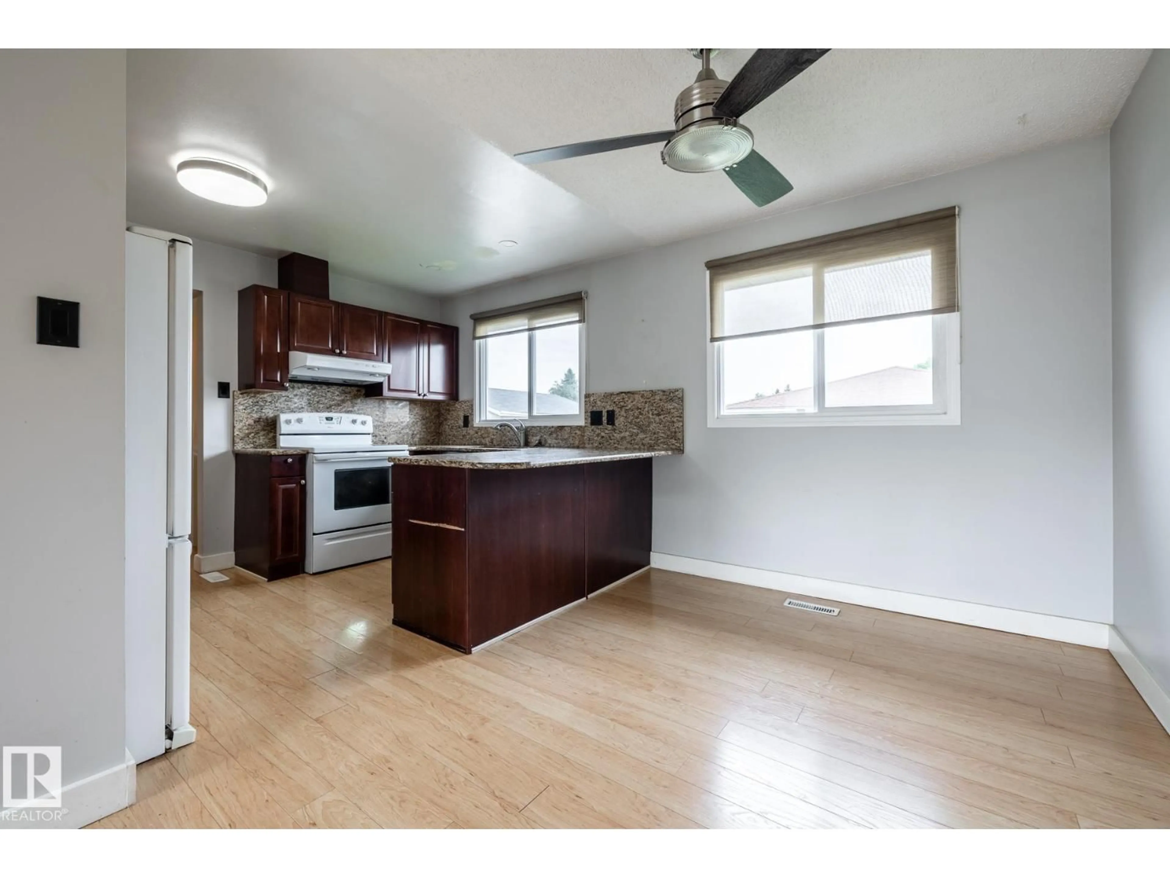Open concept kitchen, wood/laminate floor for NW - 8836 150 AV, Edmonton Alberta T5E2N5