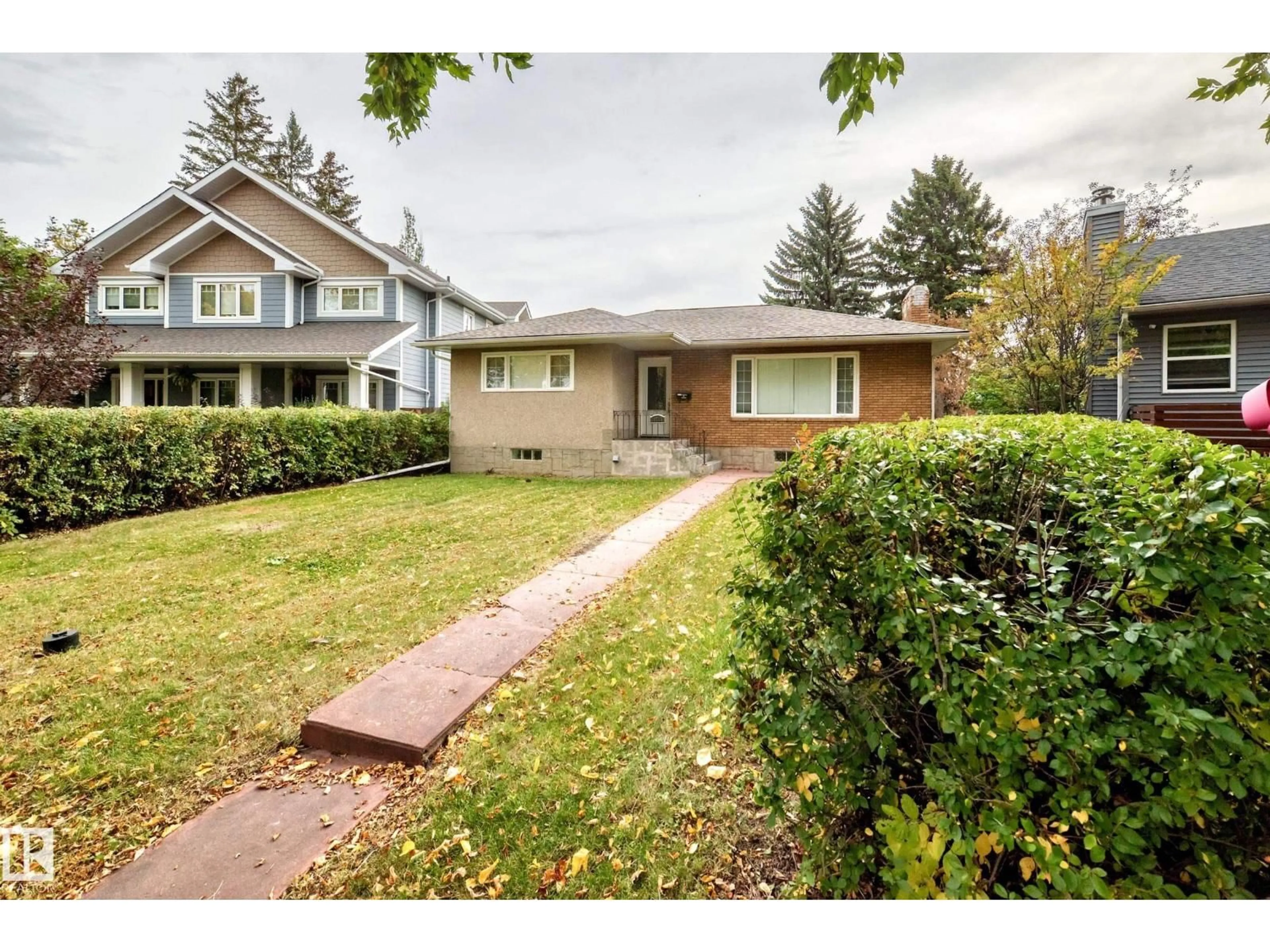 Home with vinyl exterior material, street for NW - 10715 133 ST, Edmonton Alberta T5M1G7