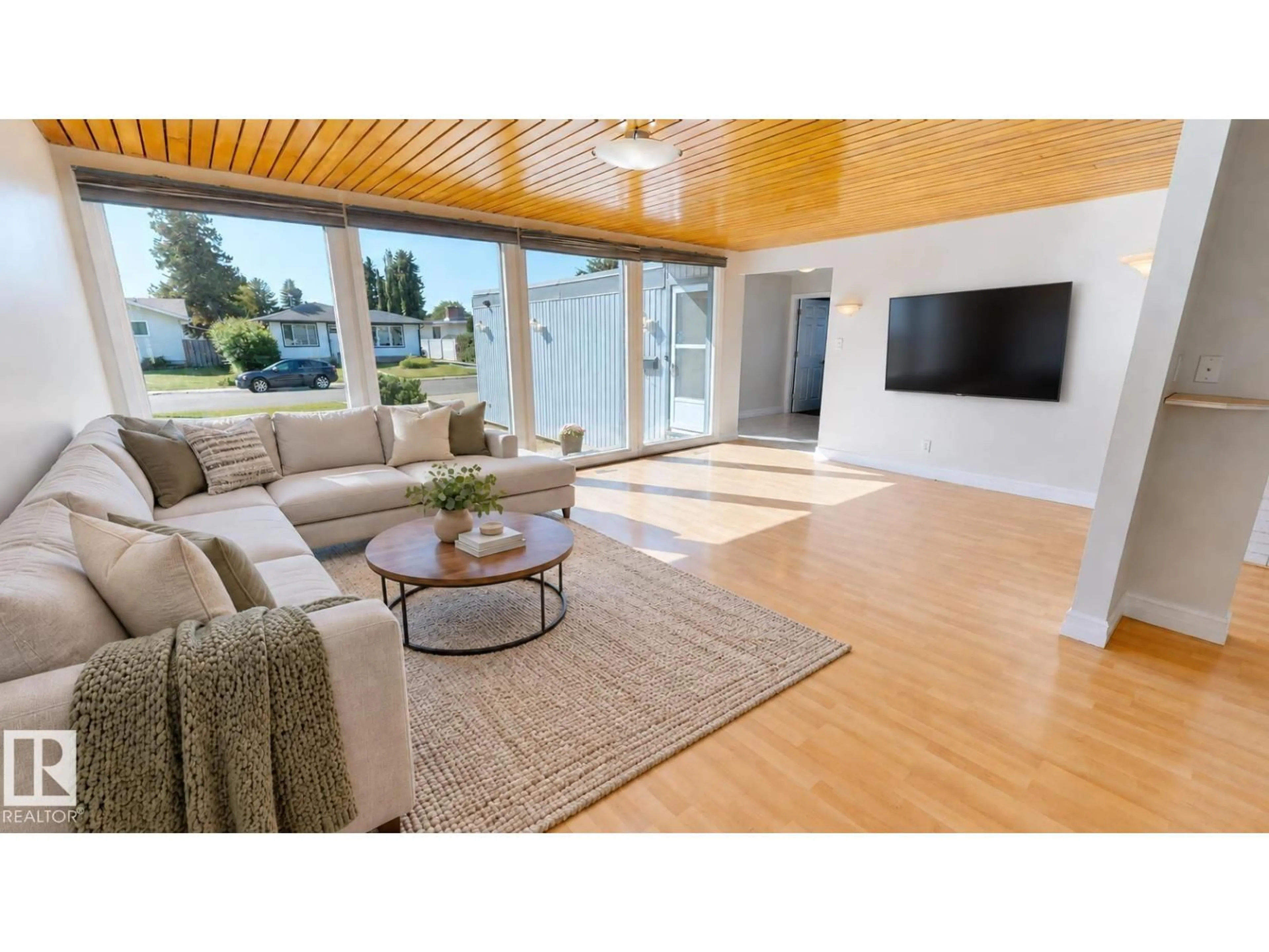 Living room with furniture, wood/laminate floor for 8204 14 AV, Edmonton Alberta T6K1X4