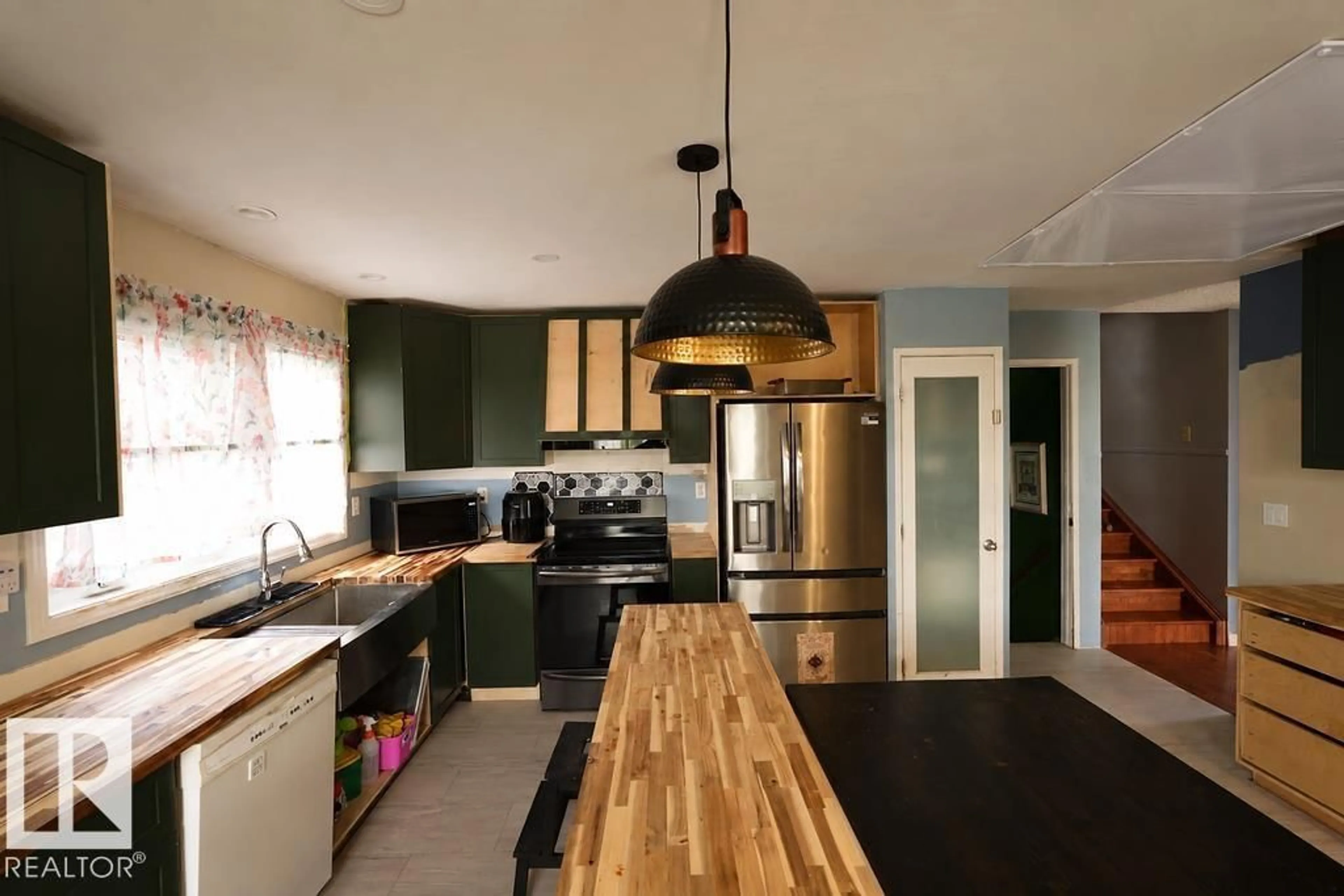 Open concept kitchen, wood/laminate floor for 13836 26 ST, Edmonton Alberta T5Y1B4