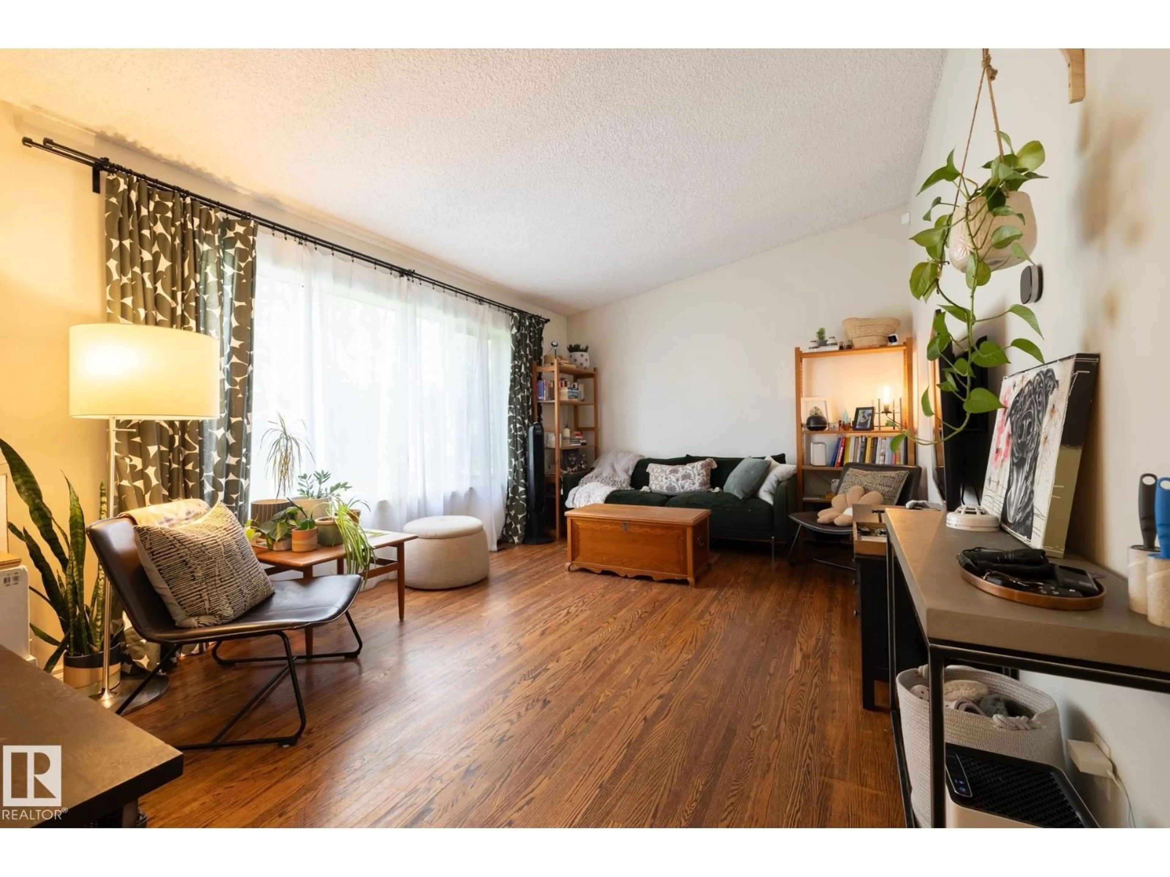 Living room with furniture, wood/laminate floor for NW - 10972 157 ST, Edmonton Alberta T5P2W3