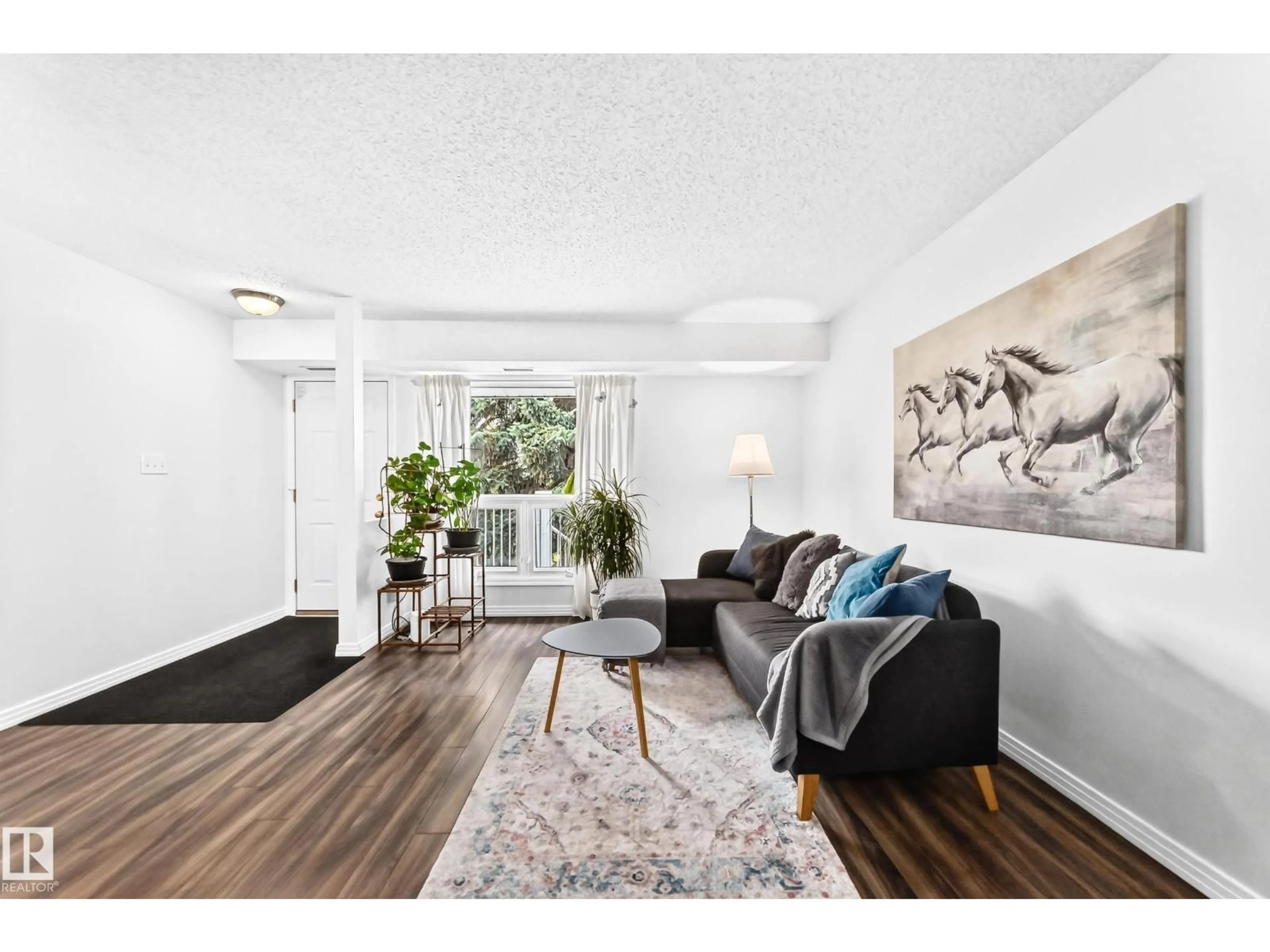 Living room with furniture, wood/laminate floor for 49 - 2115 118 ST, Edmonton Alberta T6J5N1