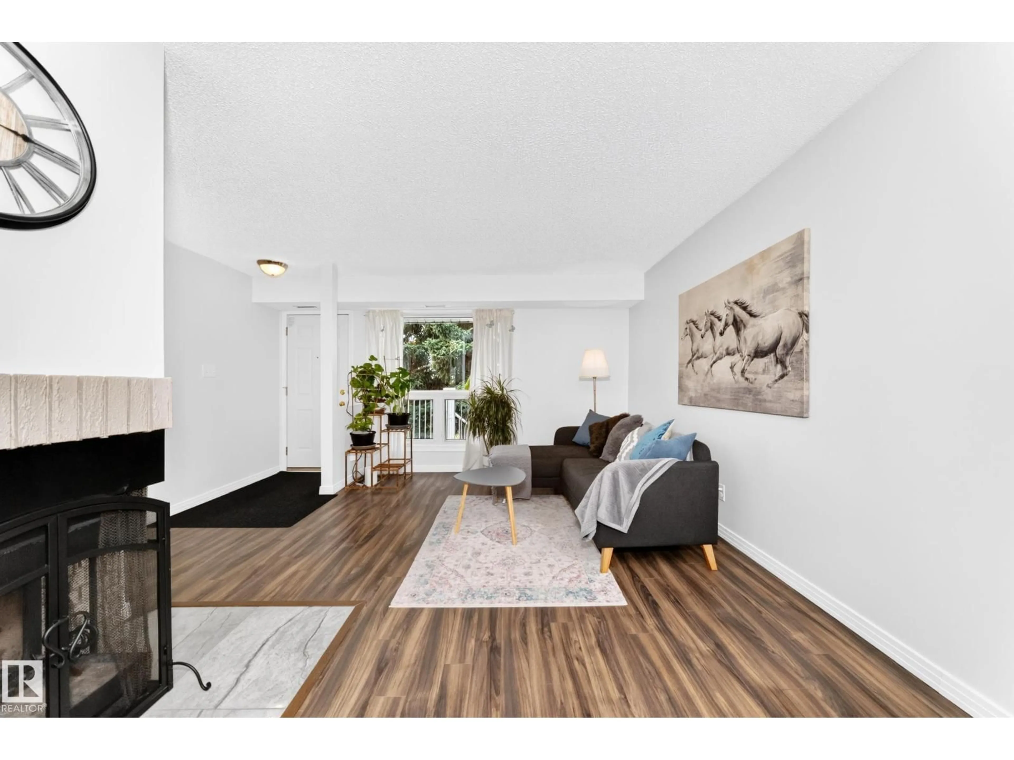 Living room with furniture, wood/laminate floor for 49 - 2115 118 ST, Edmonton Alberta T6J5N1