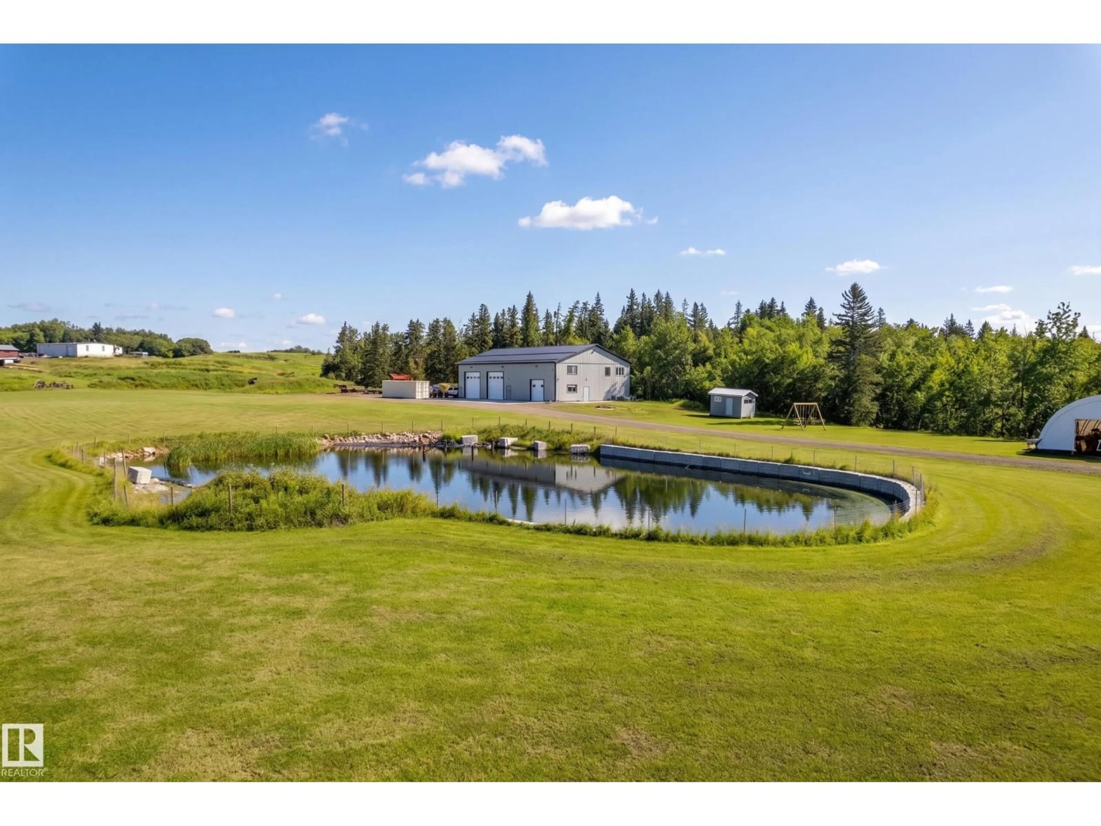A pic from outside/outdoor area/front of a property/back of a property/a pic from drone, water/lake/river/ocean view for 49279 RGE RD 240, Rural Leduc County Alberta T4X0Z6
