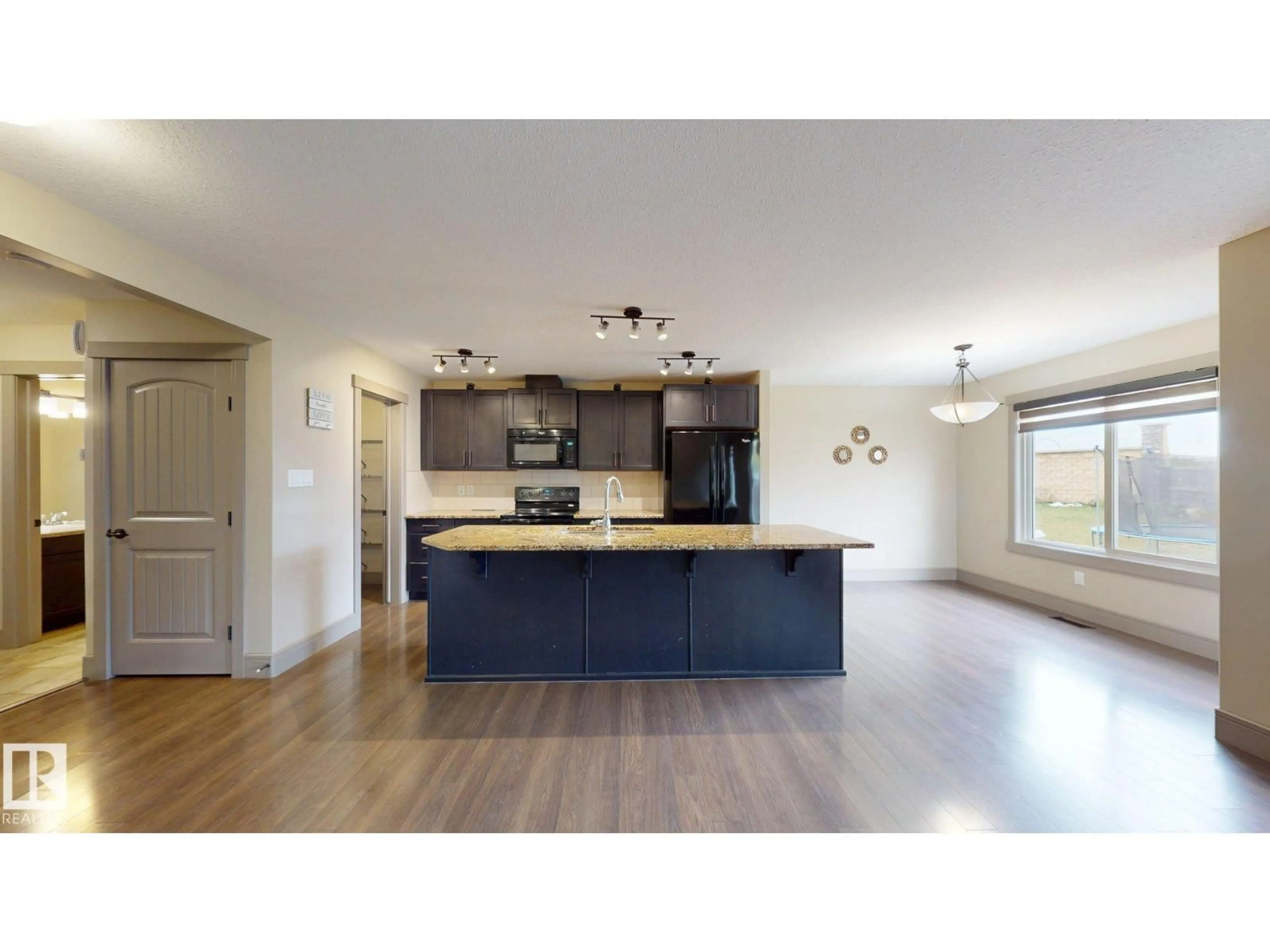 Open concept kitchen, wood/laminate floor for 4826 171A AV, Edmonton Alberta T5Y3P3