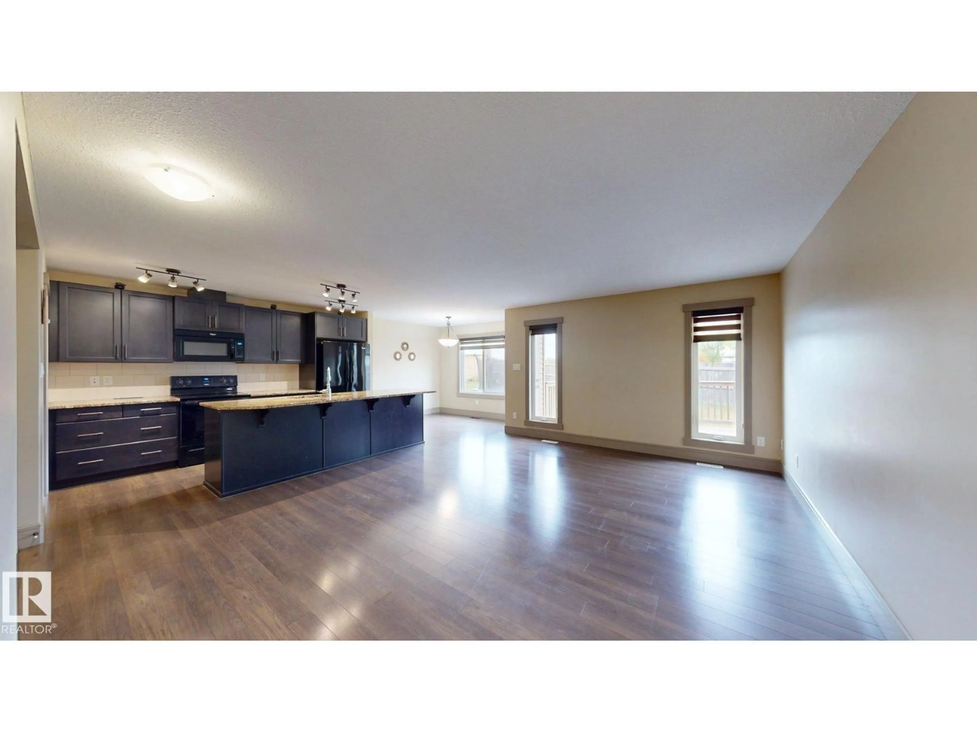 Open concept kitchen, wood/laminate floor for 4826 171A AV, Edmonton Alberta T5Y3P3