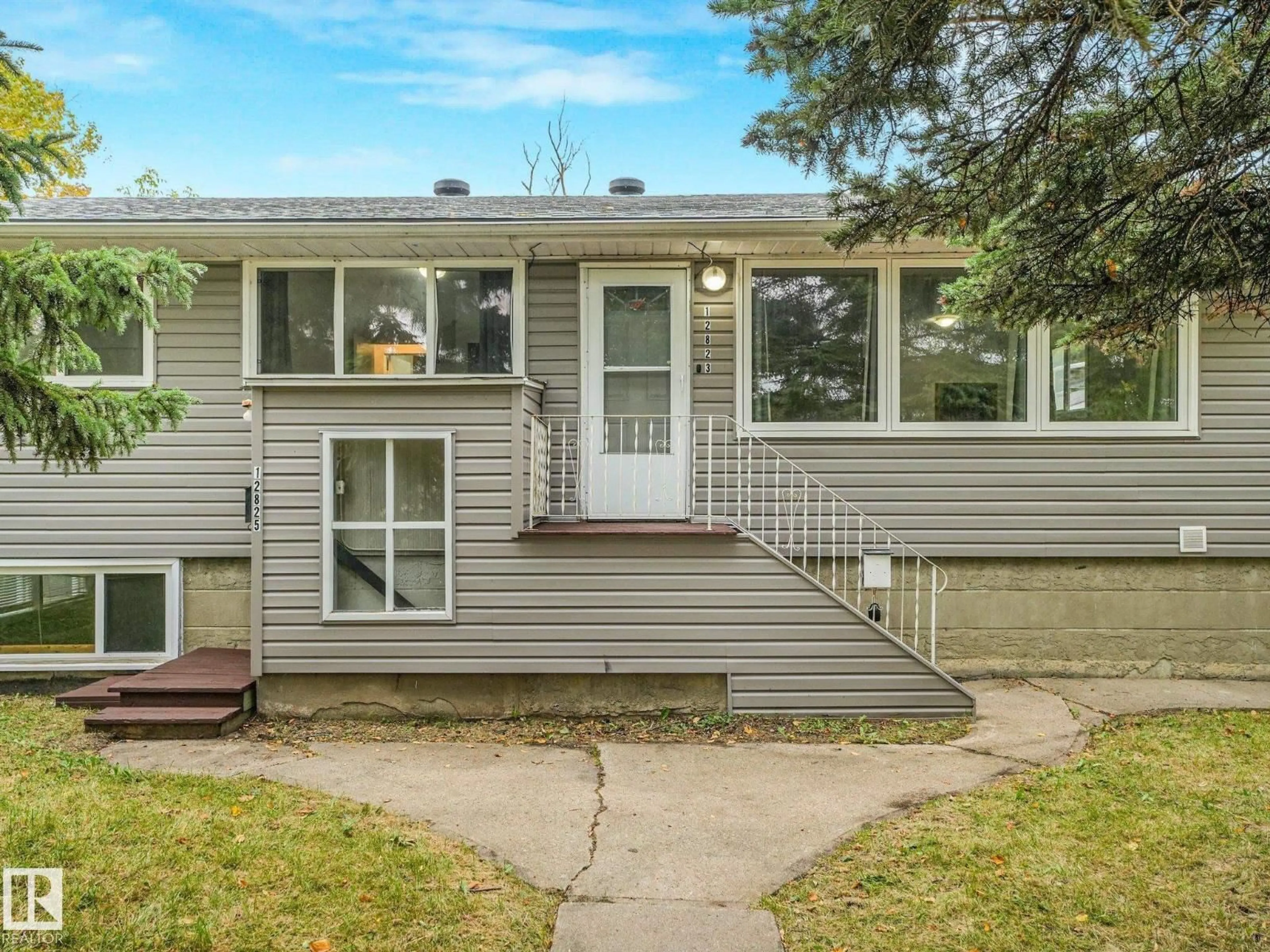 Home with vinyl exterior material, street for 12823 125 ST, Edmonton Alberta T5L0V1