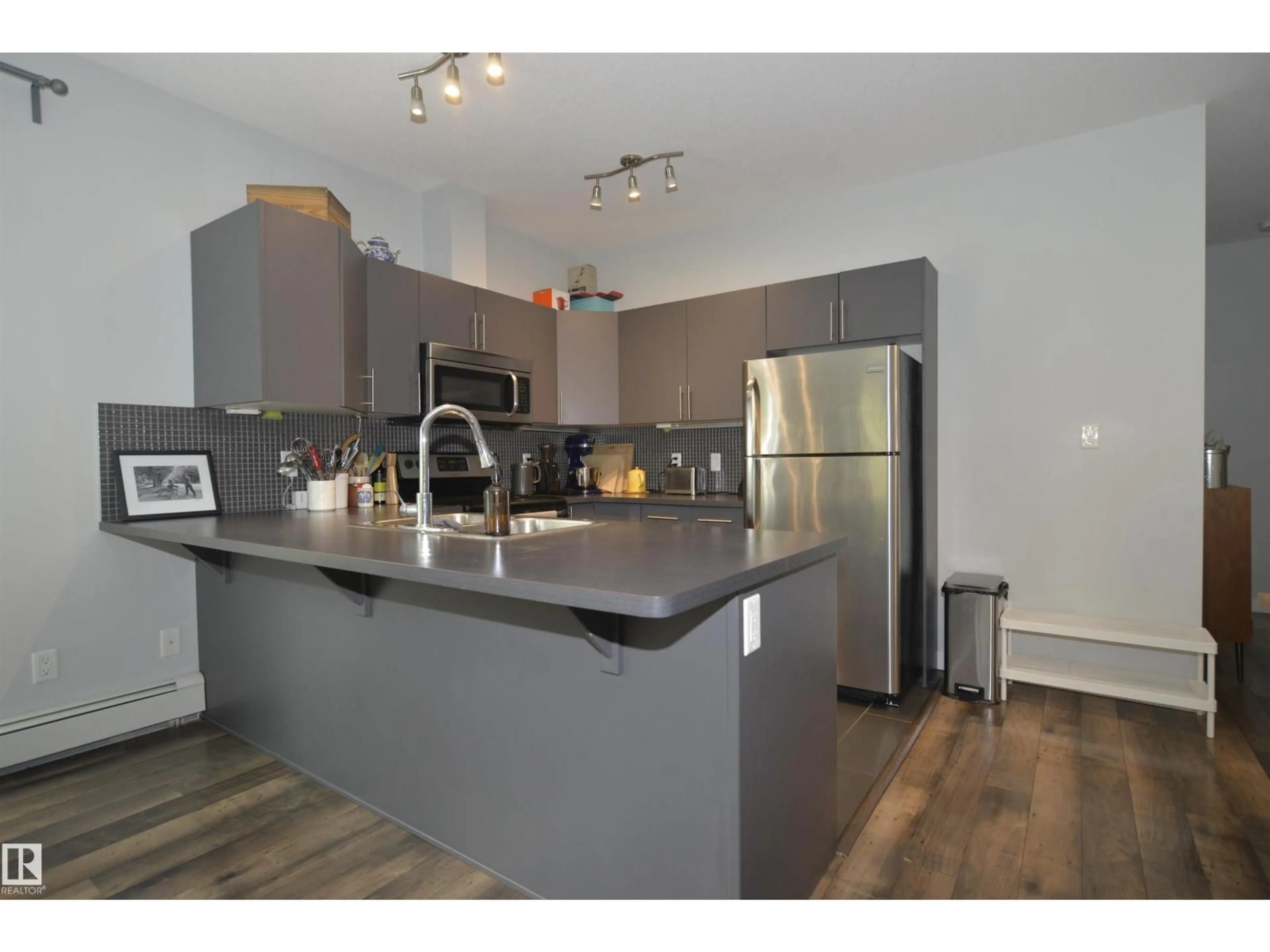 Open concept kitchen, wood/laminate floor for #304 - 10611 117 ST, Edmonton Alberta T5H0G6