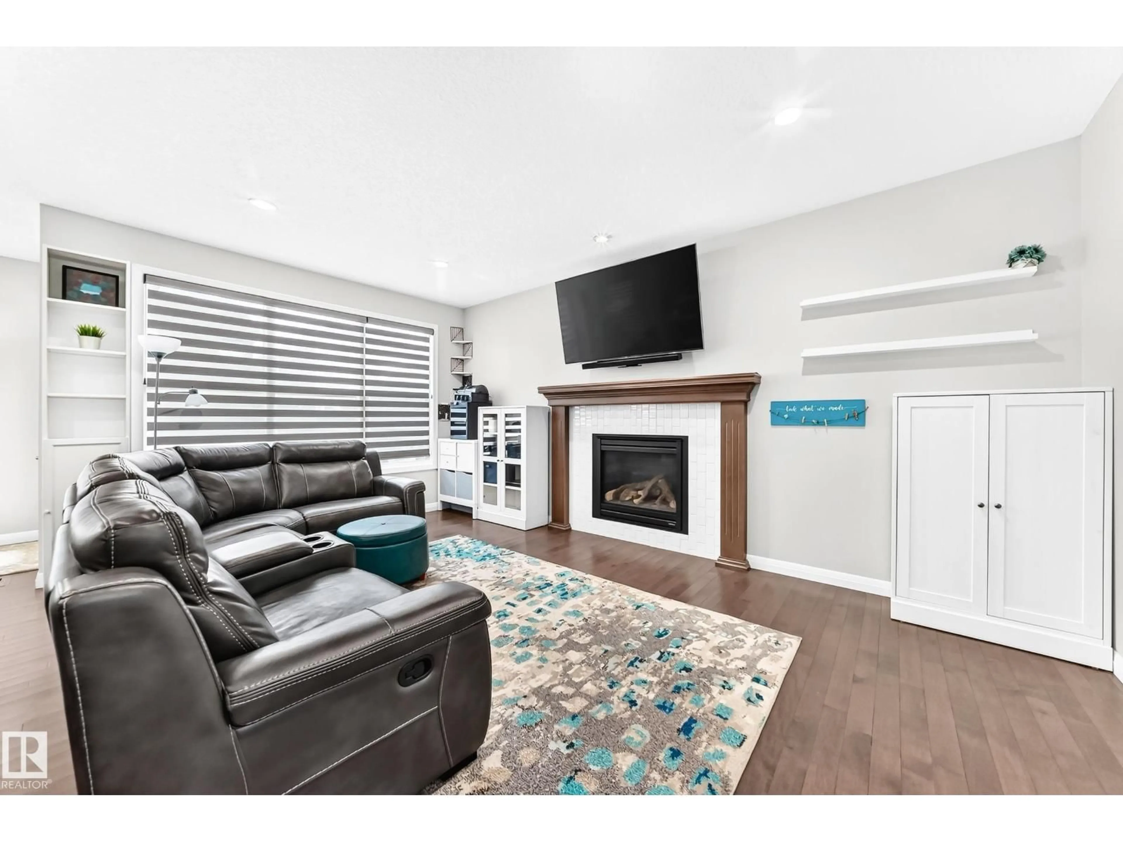 Living room with furniture, wood/laminate floor for NW - 5718 175A AV, Edmonton Alberta T5Y0T7