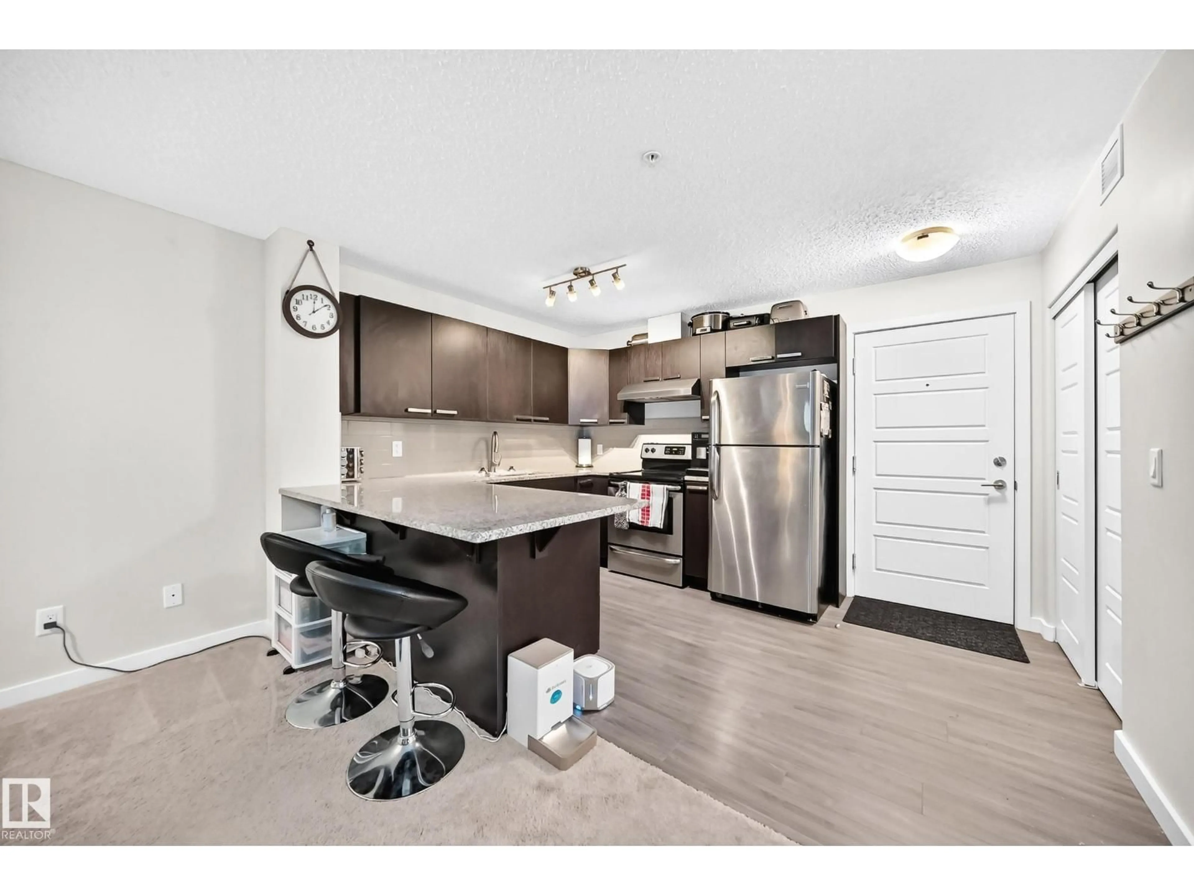 Open concept kitchen, wood/laminate floor for #115 - 14808 125 ST, Edmonton Alberta T5X0G1