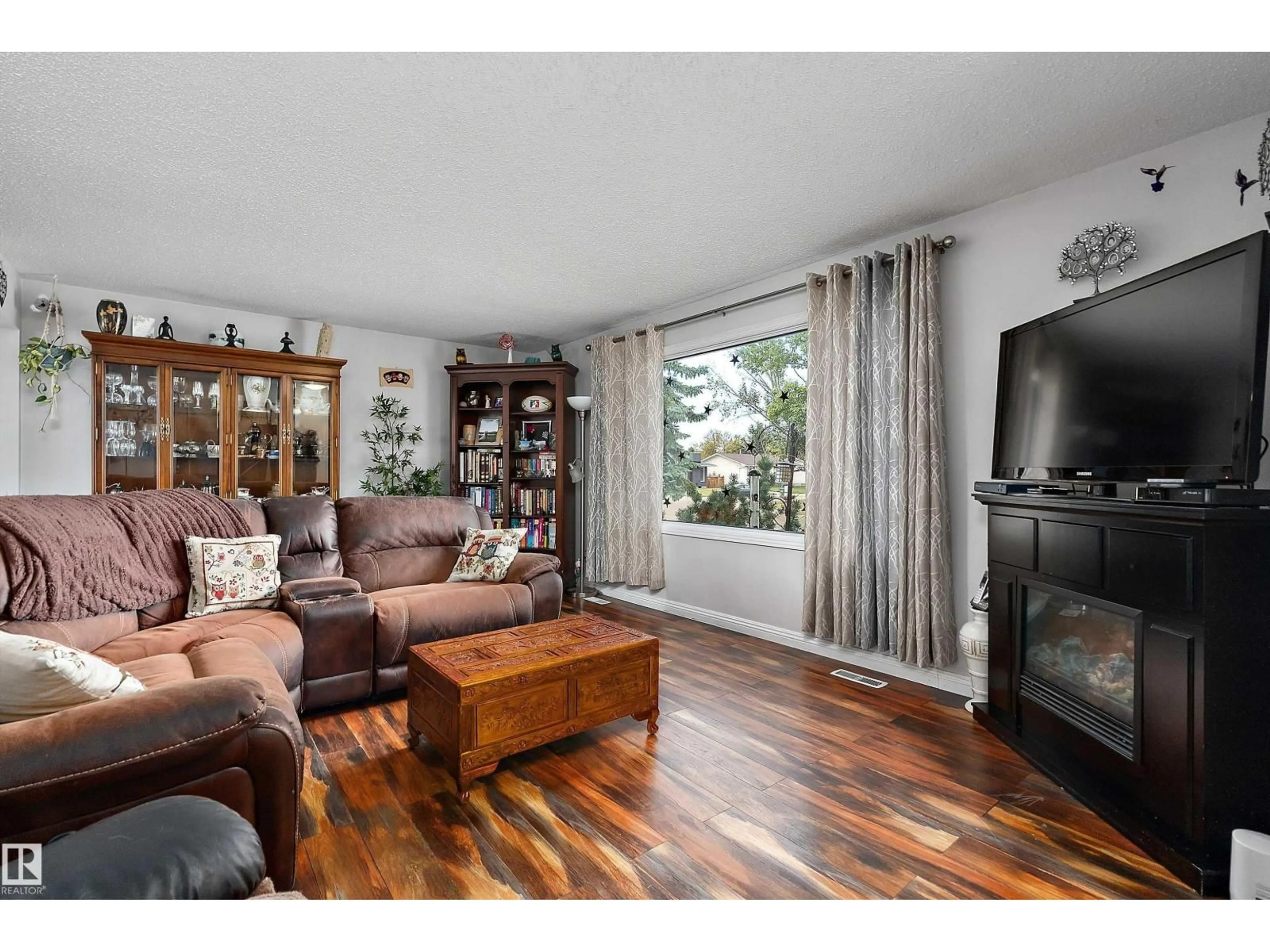 Living room with furniture, wood/laminate floor for NW - 12211 147 AV, Edmonton Alberta T5X1V4