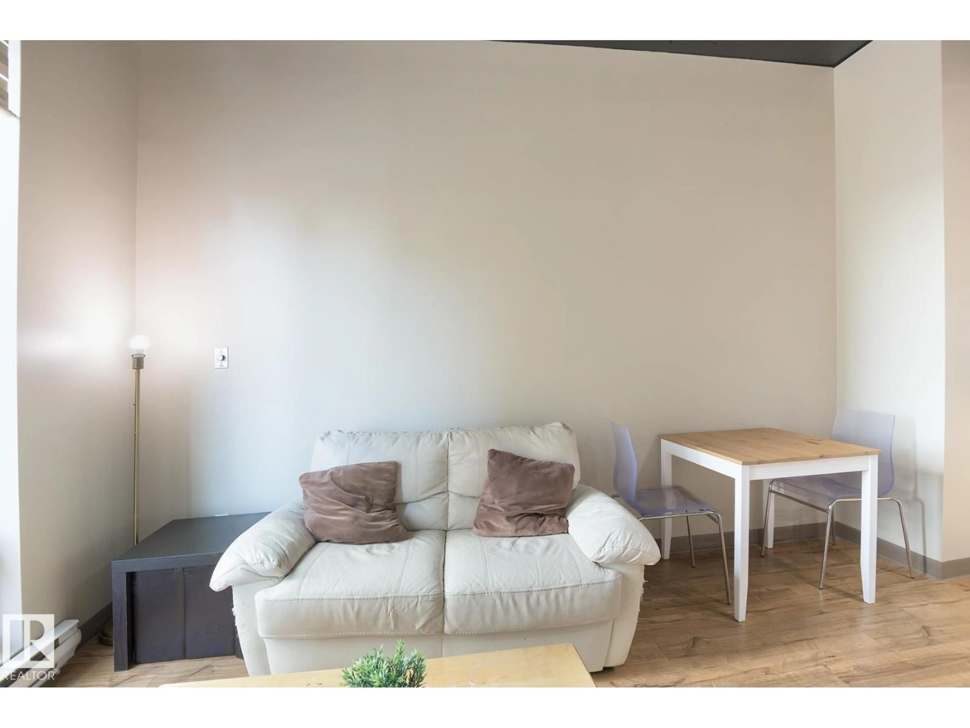 Living room with furniture, wood/laminate floor for 10024 - 412 JASPER AV, Edmonton Alberta T5J1R9