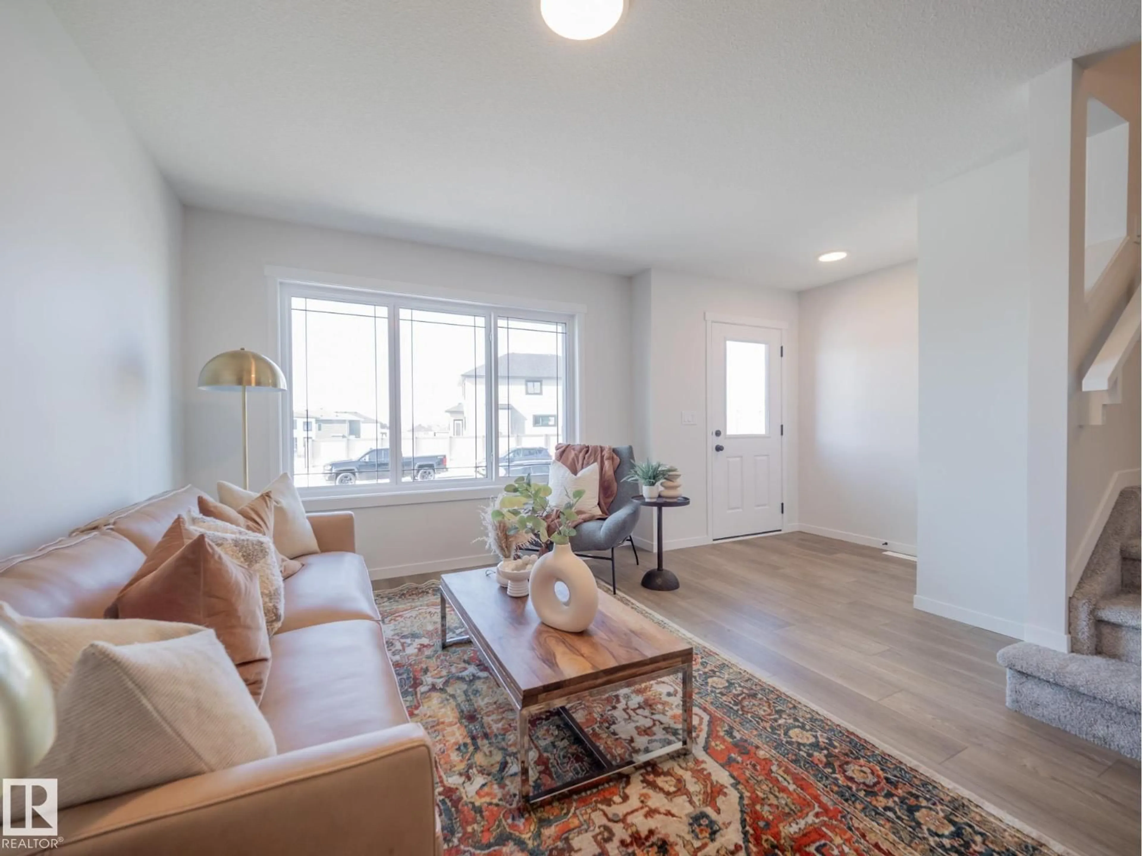Living room with furniture, wood/laminate floor for 5224 SCHONSEE DR, Edmonton Alberta T5Z0M5