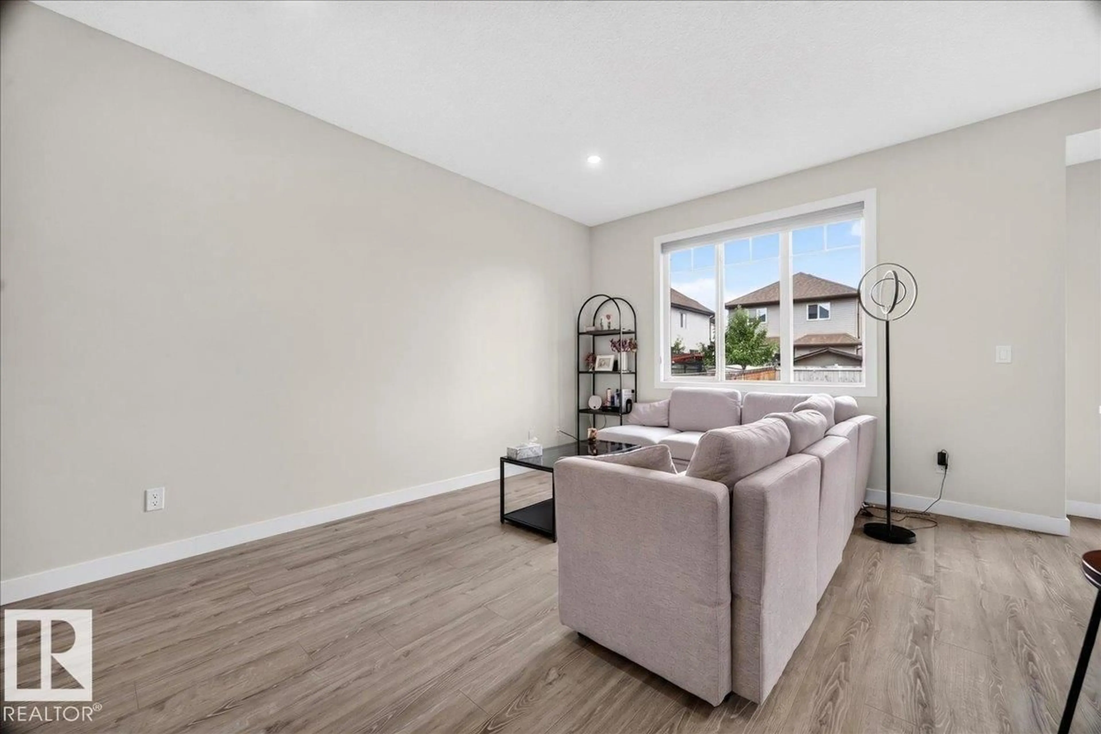 Living room with furniture, wood/laminate floor for 100 MEADOWLAND CR, Spruce Grove Alberta T7X0P6