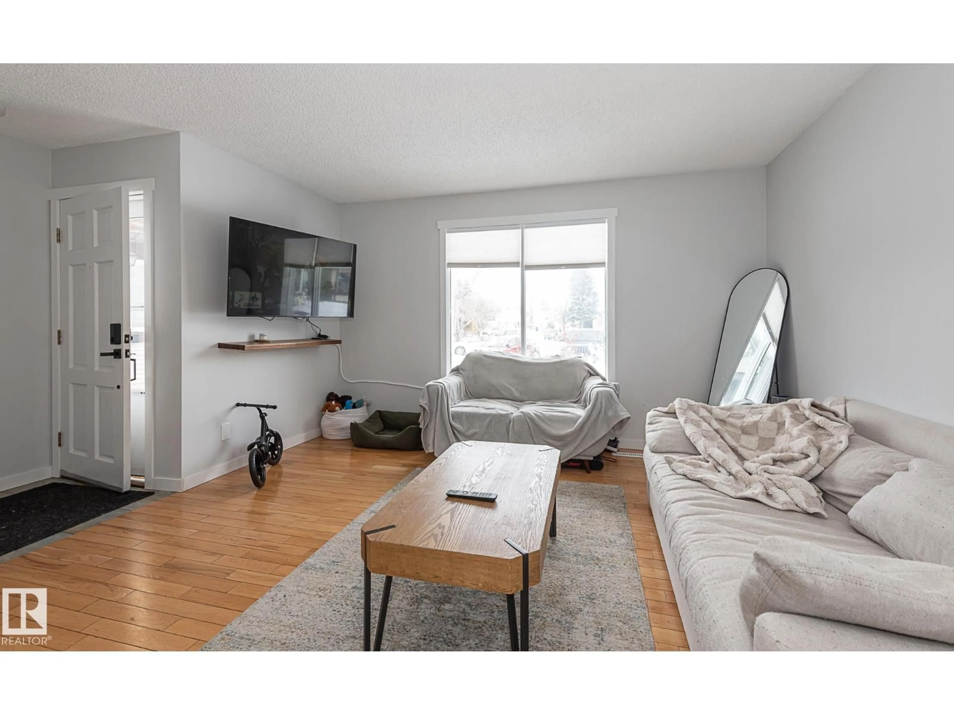 Living room with furniture, wood/laminate floor for NW - 8326 157 AV, Edmonton Alberta T5Z2P7