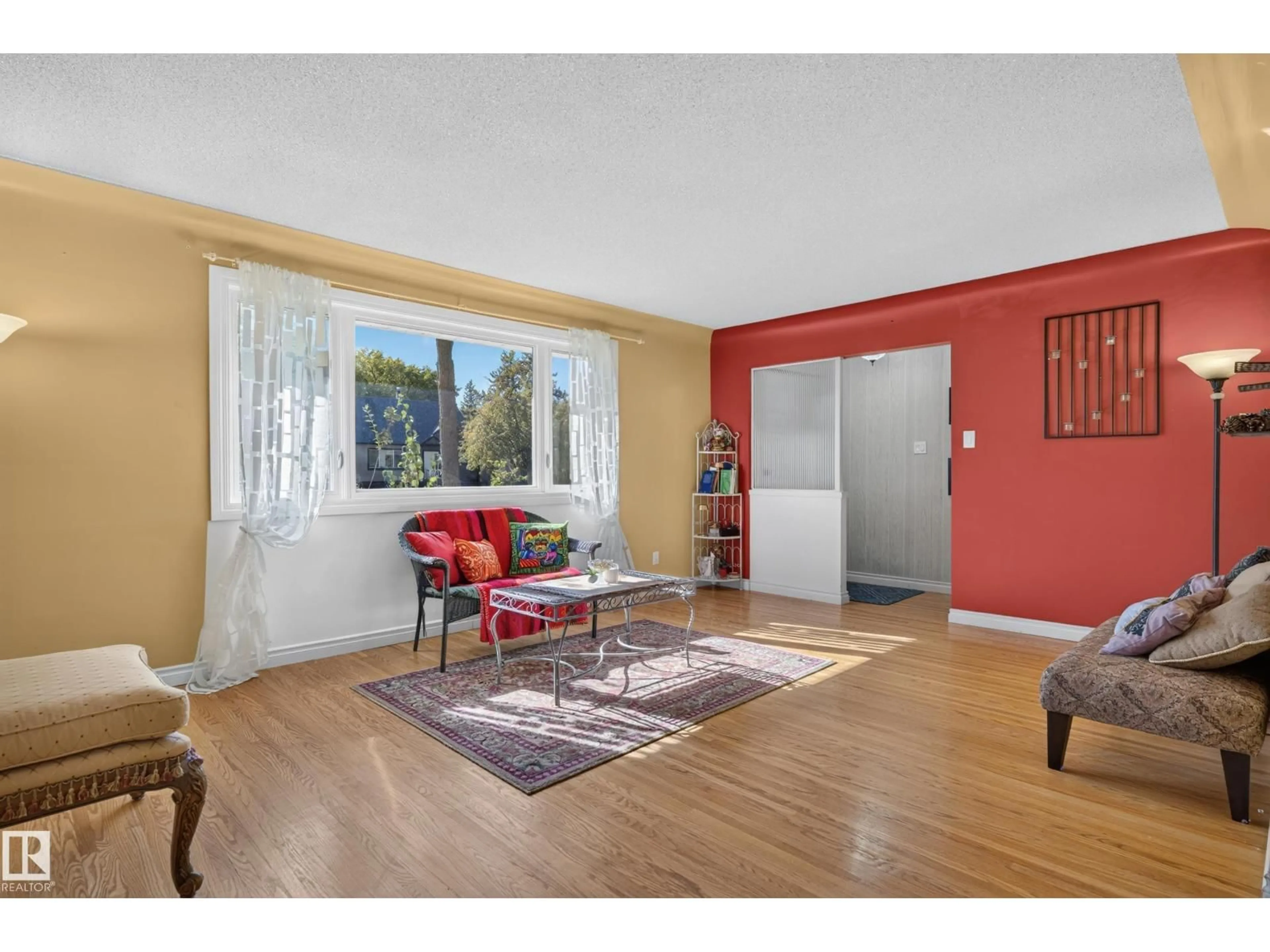 Living room with furniture, wood/laminate floor for 13636 122 AV, Edmonton Alberta T5L2V8