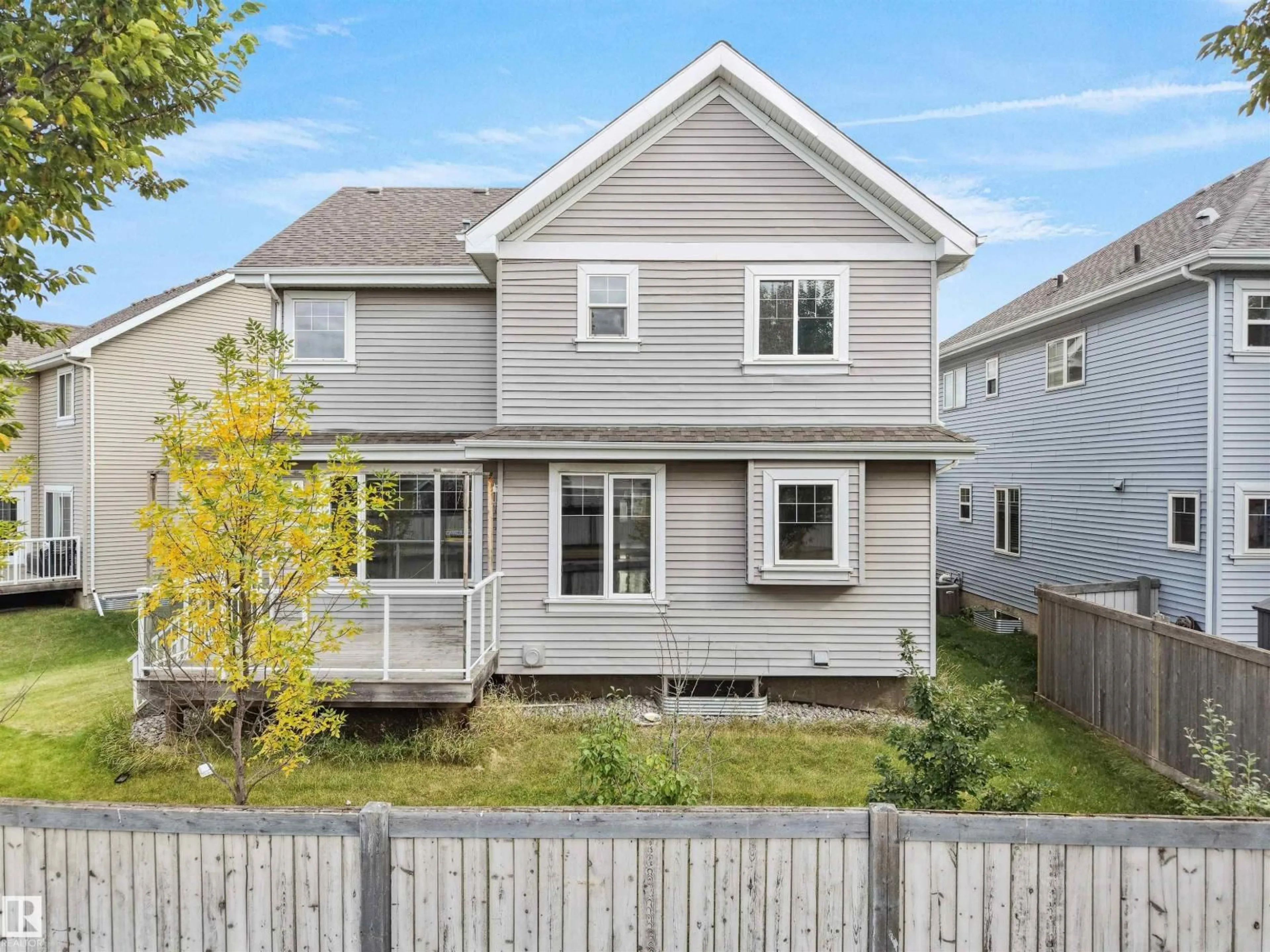 Home with vinyl exterior material, street for 7628 10 AV SW, Edmonton Alberta T6X0N6