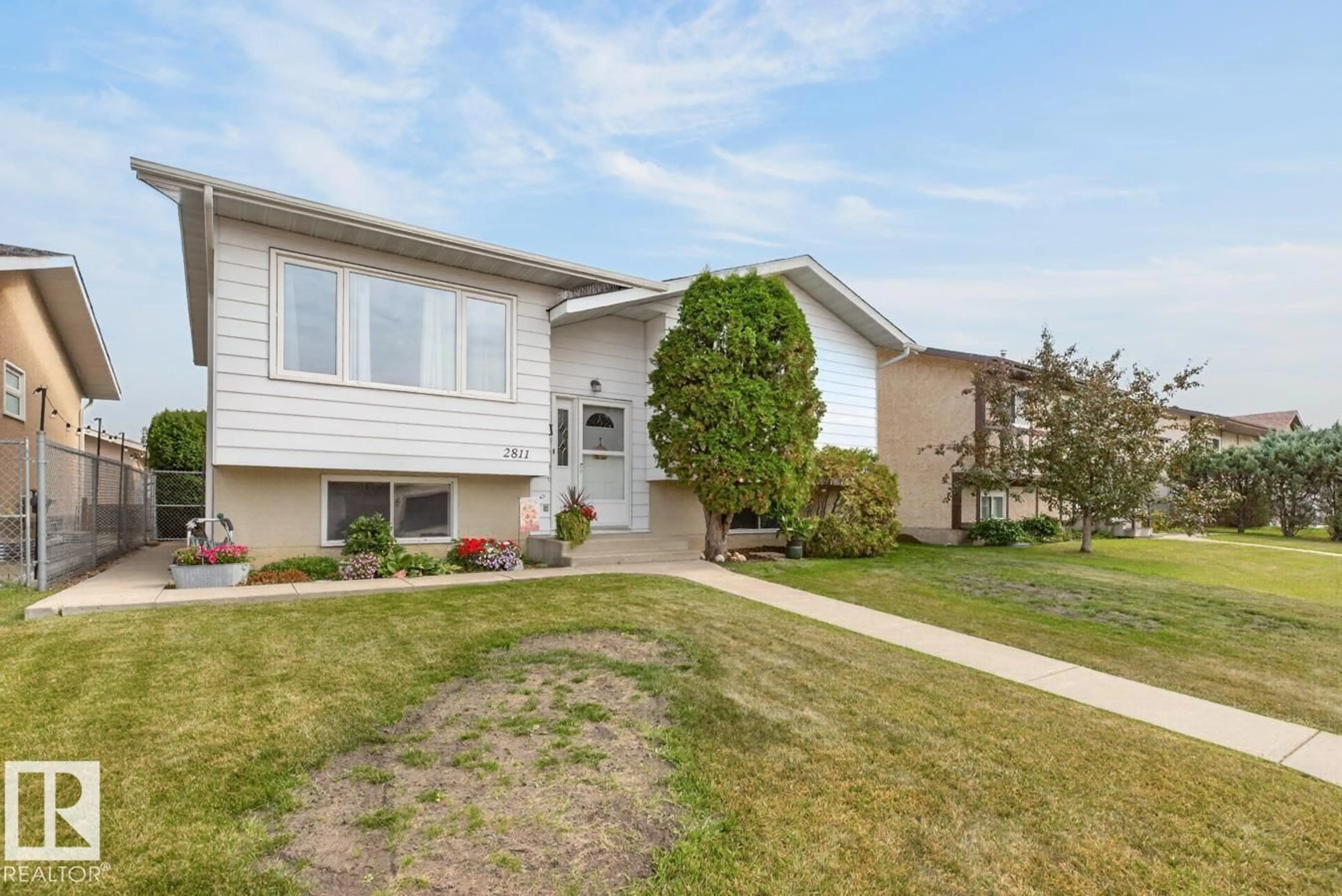Home with vinyl exterior material, street for NW - 2811 37 ST, Edmonton Alberta T6L4G4