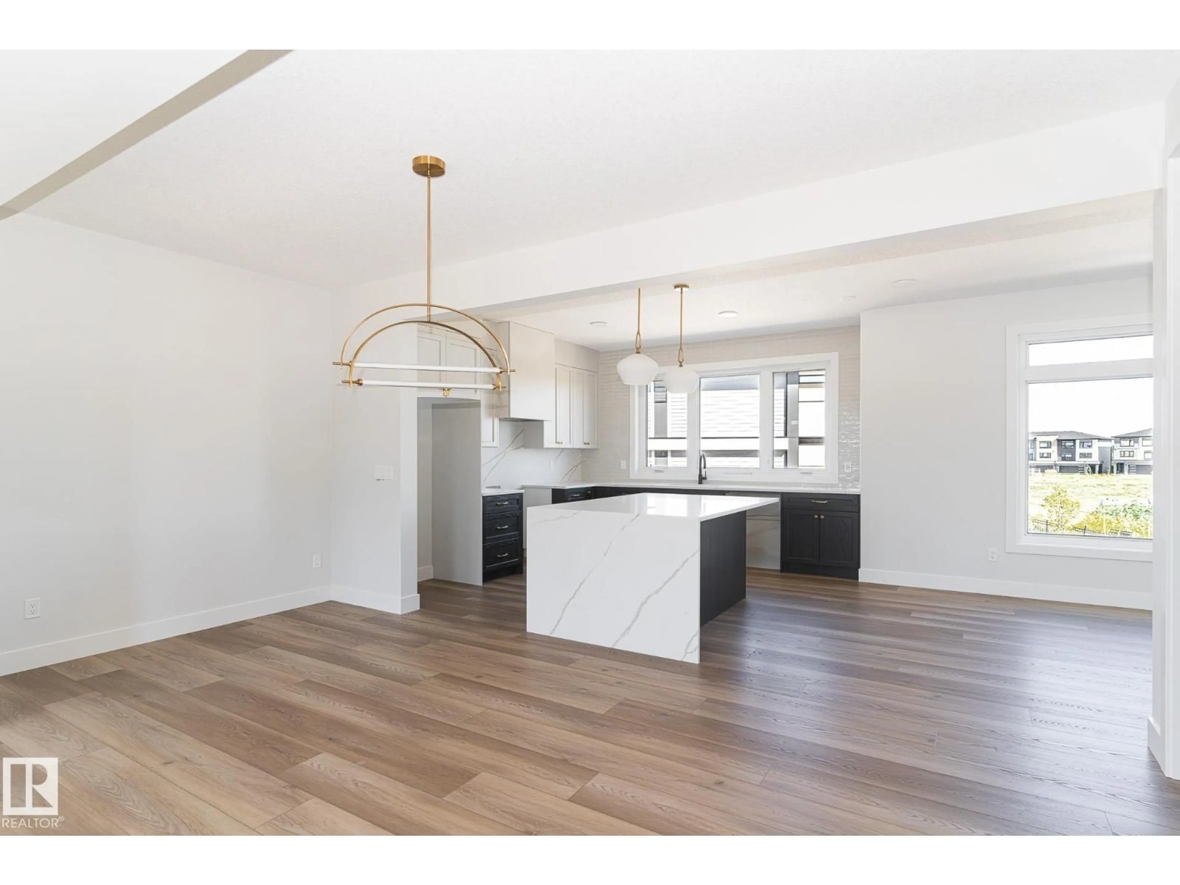 Open concept kitchen, wood/laminate floor for #42 - 7121 MAY CR, Edmonton Alberta T6R0X2