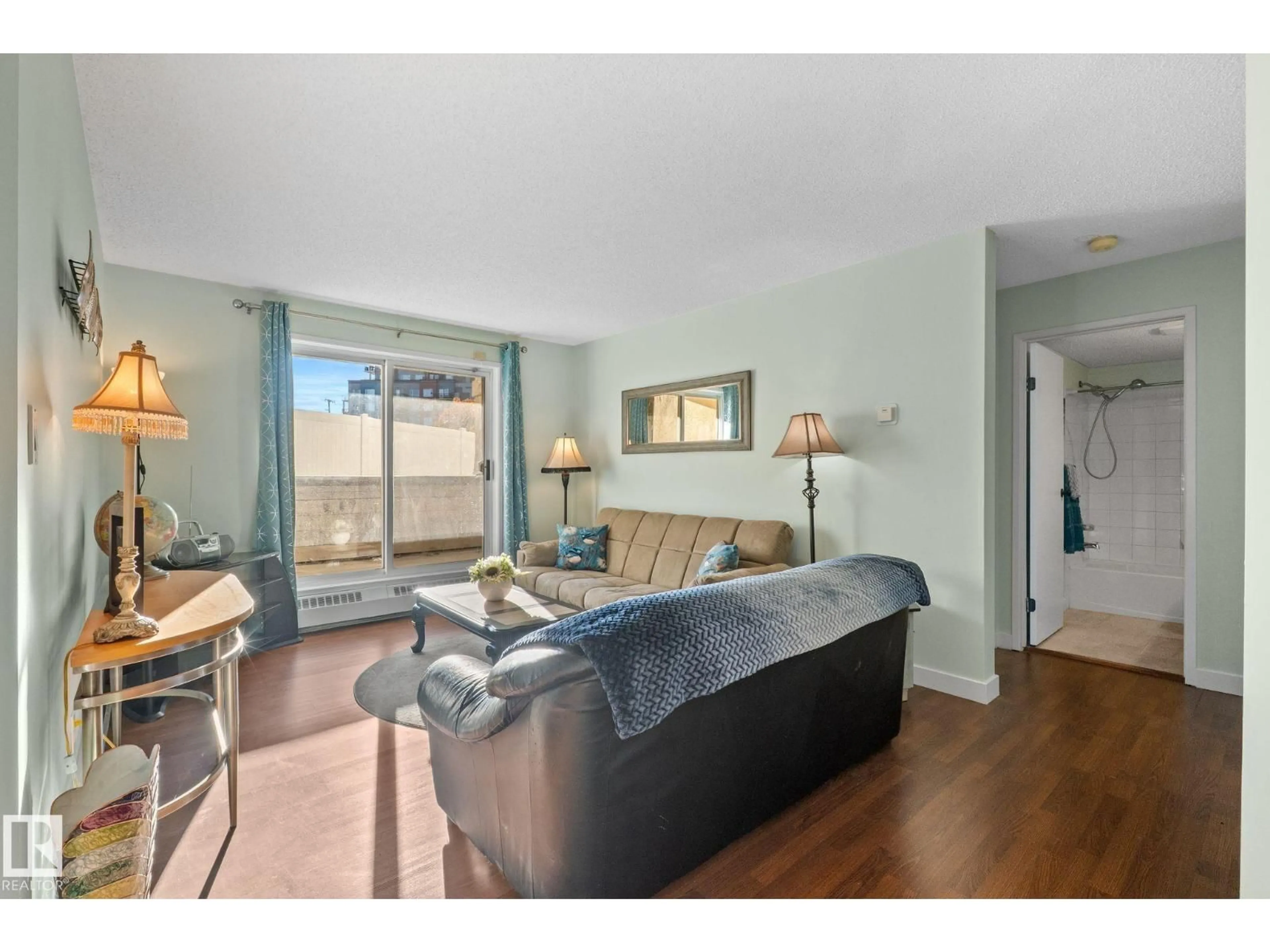 Living room with furniture, wood/laminate floor for 163 10520 120 ST NW, Edmonton Alberta T5H4L9