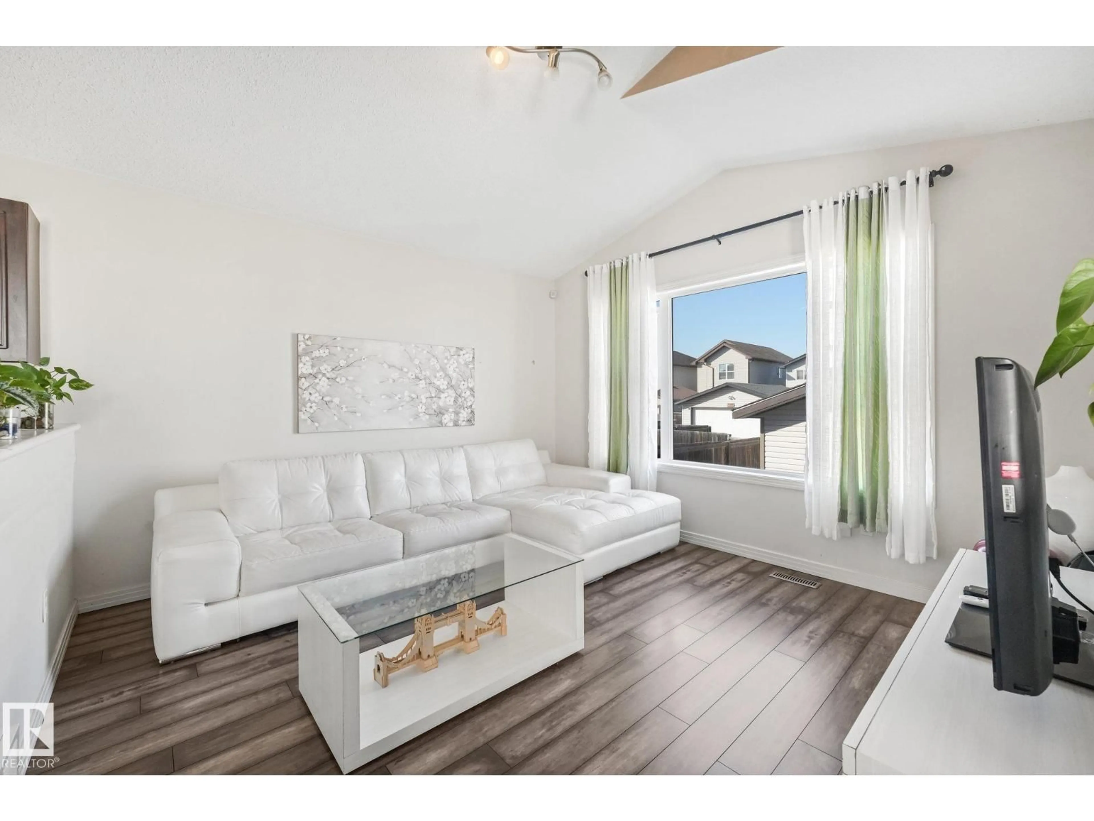 Living room with furniture, wood/laminate floor for 11644 167A AV, Edmonton Alberta T5X6J5