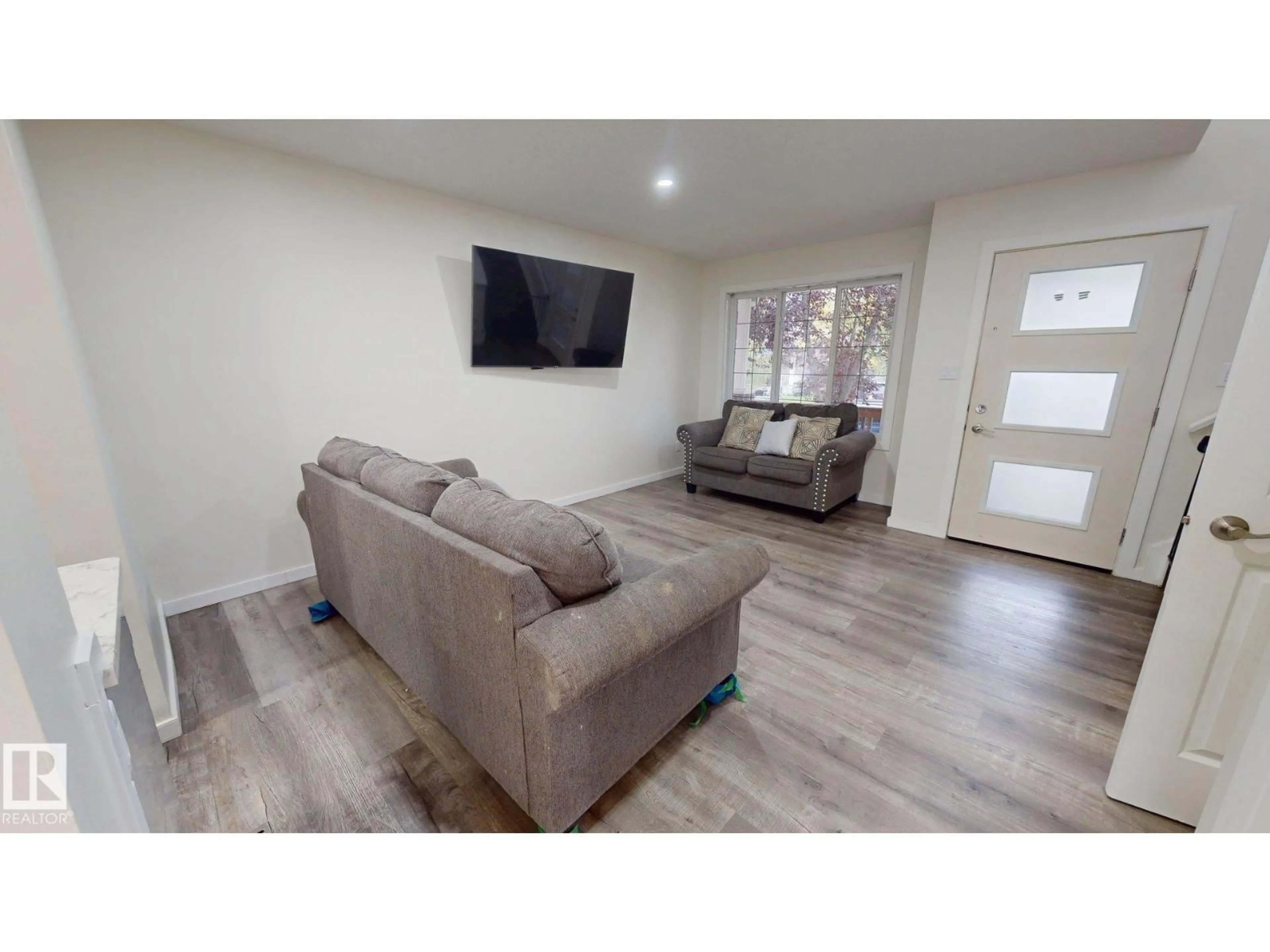 Living room with furniture, wood/laminate floor for 17 VISTA, Spruce Grove Alberta T7X4P6