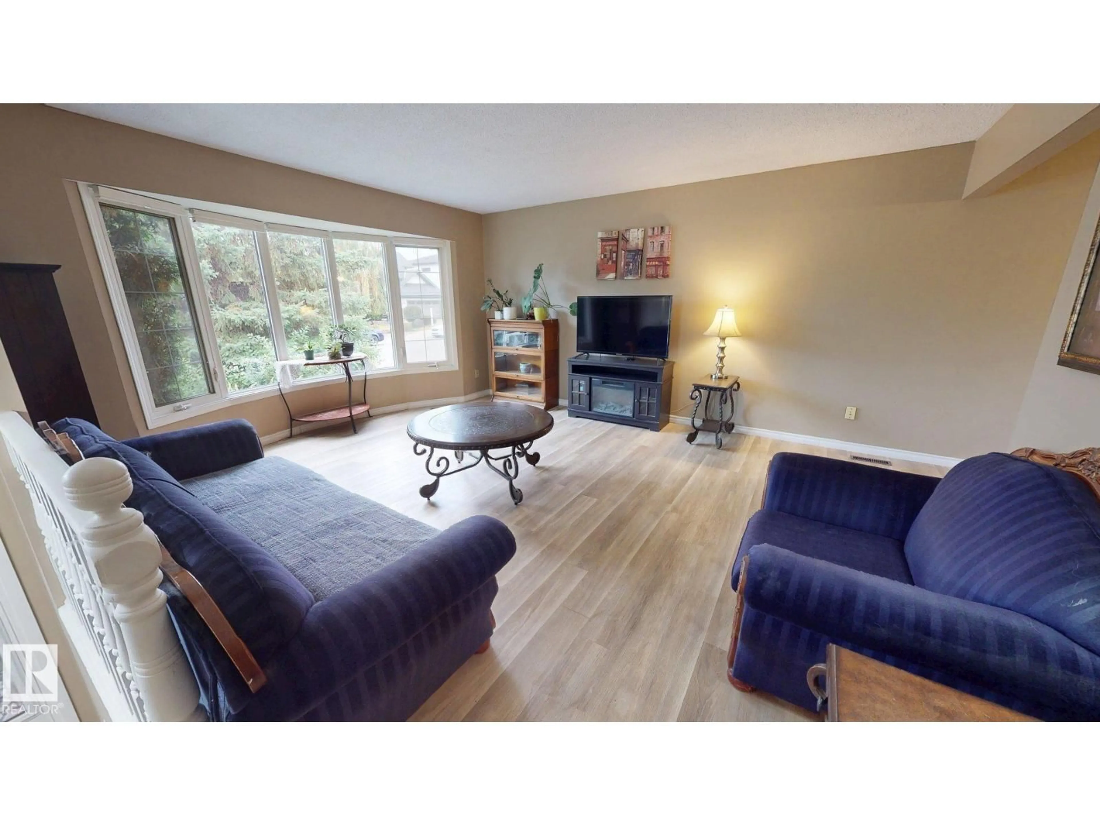 Living room with furniture, wood/laminate floor for 9813 152 ST, Edmonton Alberta T5P1X2