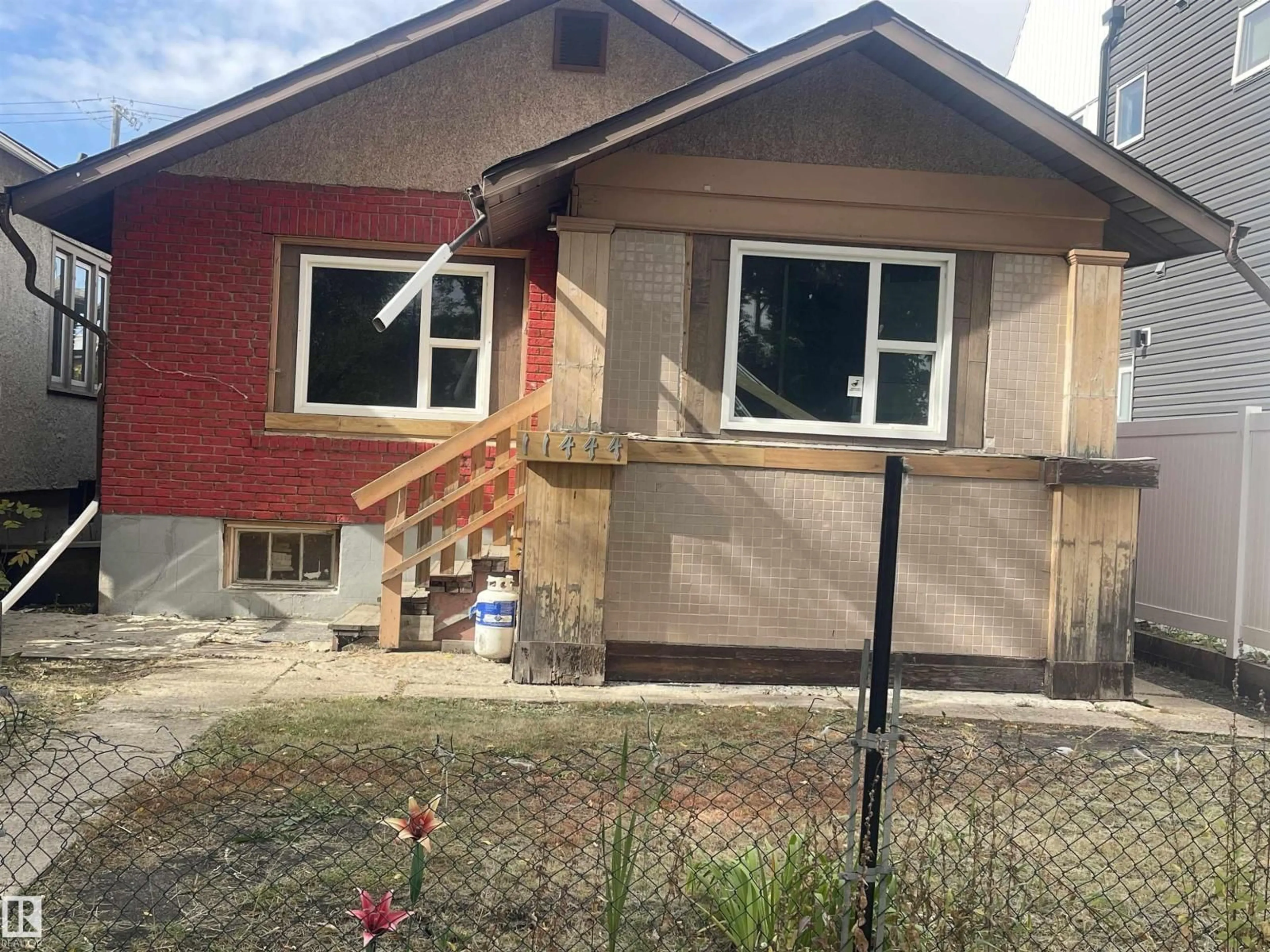 Home with vinyl exterior material, street for 11444 97 ST, Edmonton Alberta T5G1X5