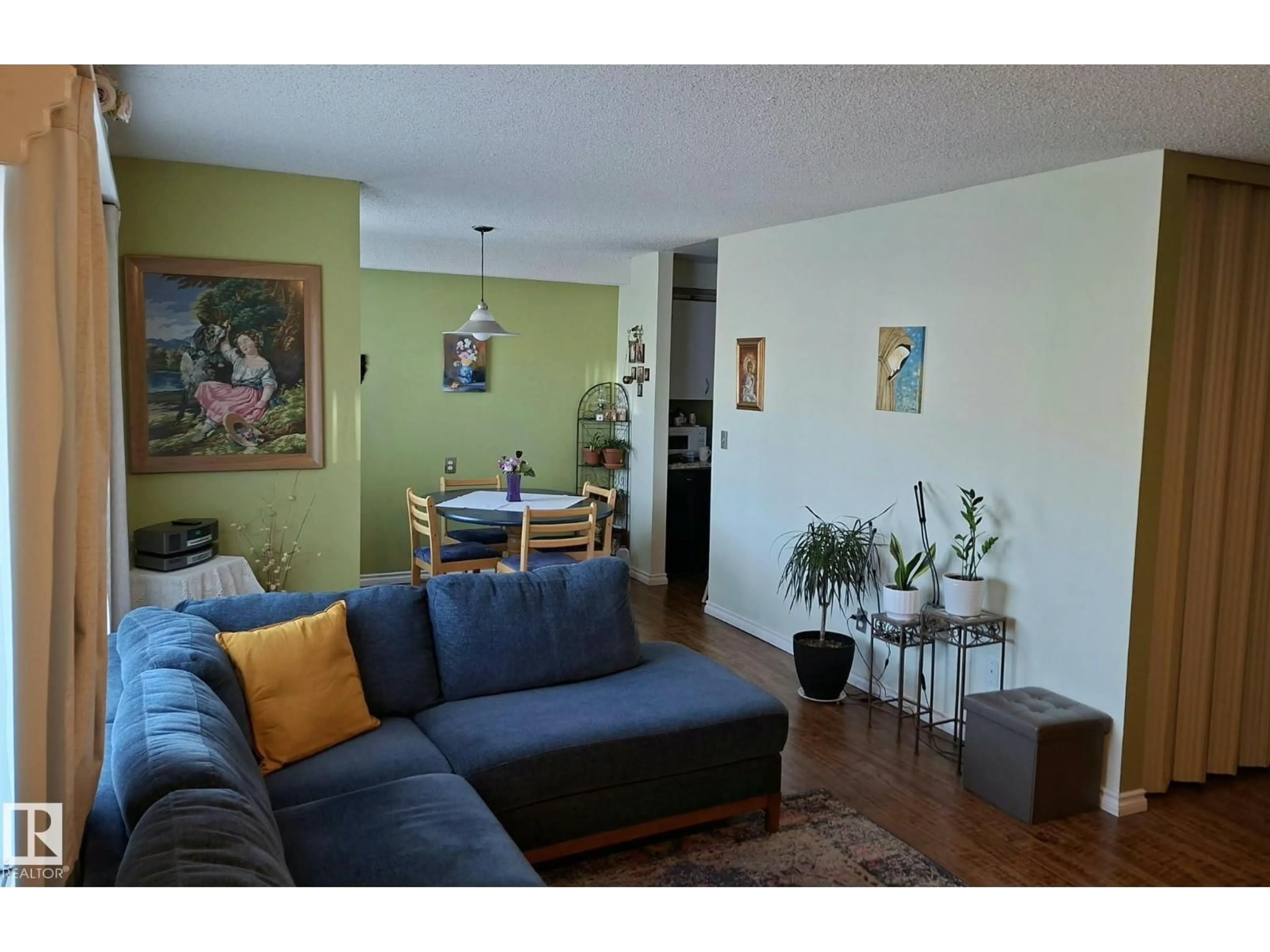 Living room with furniture, wood/laminate floor for 109 - 10838 108 ST, Edmonton Alberta T5H3A6