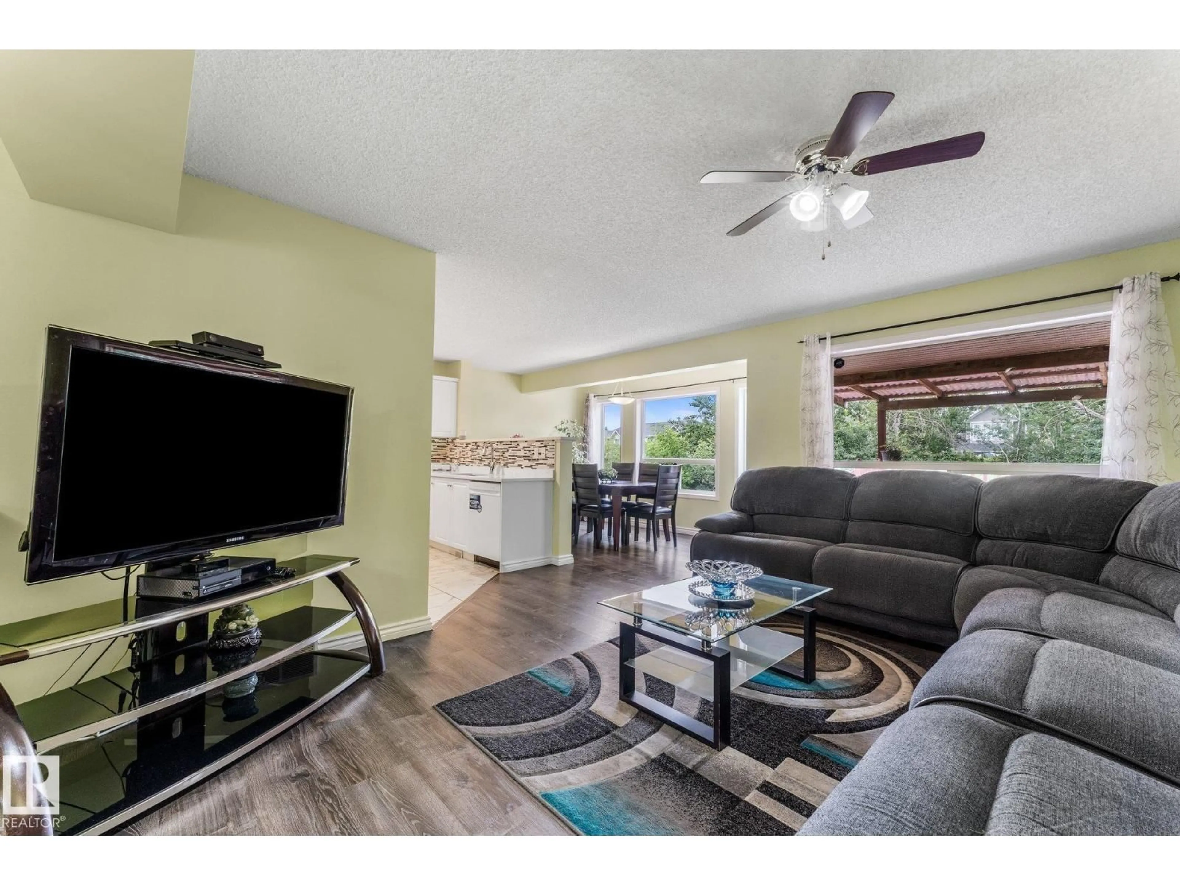 Living room with furniture, wood/laminate floor for 13148 151 AV, Edmonton Alberta T6V1K8