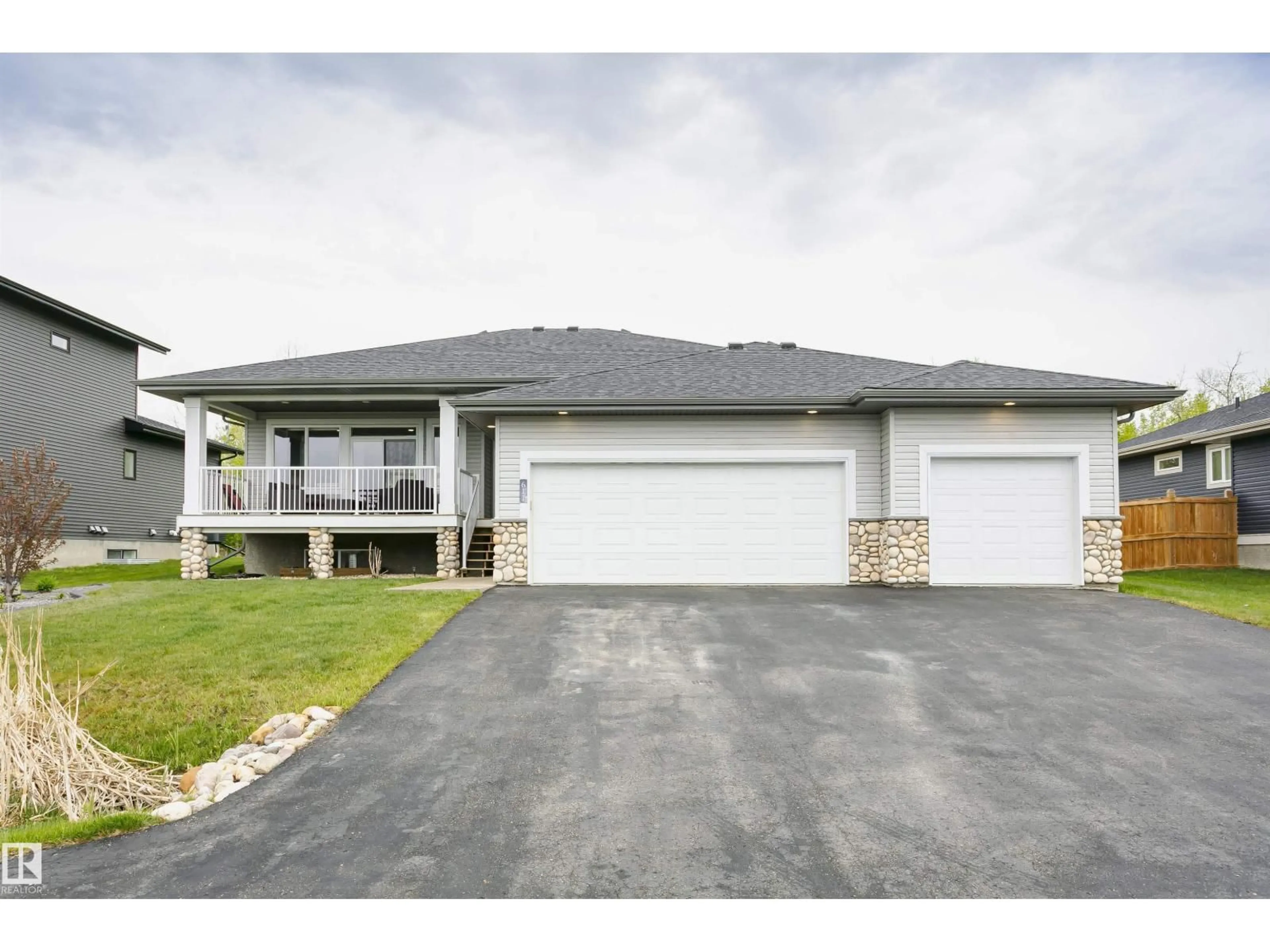 Home with vinyl exterior material, street for 611 55101 STE ANNE TRAIL, Rural Lac Ste. Anne County Alberta T0E1A1