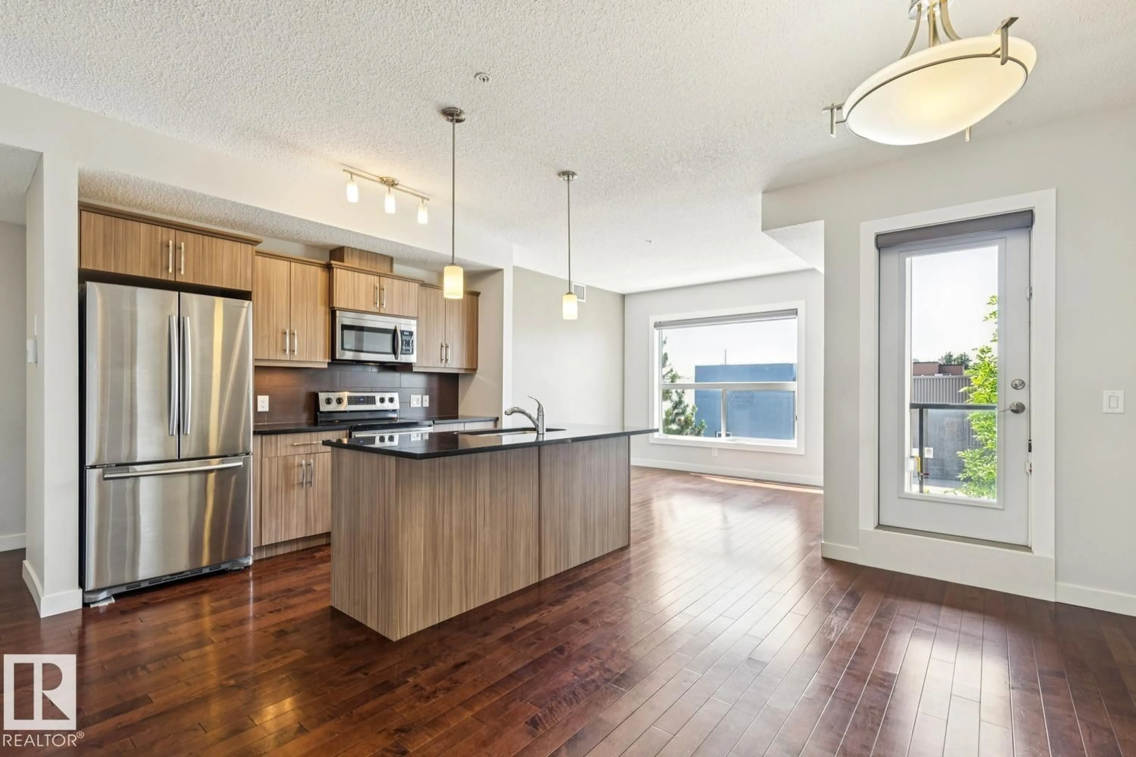 Open concept kitchen, wood/laminate floor for #217 - 10523 123 ST, Edmonton Alberta T5N1N9